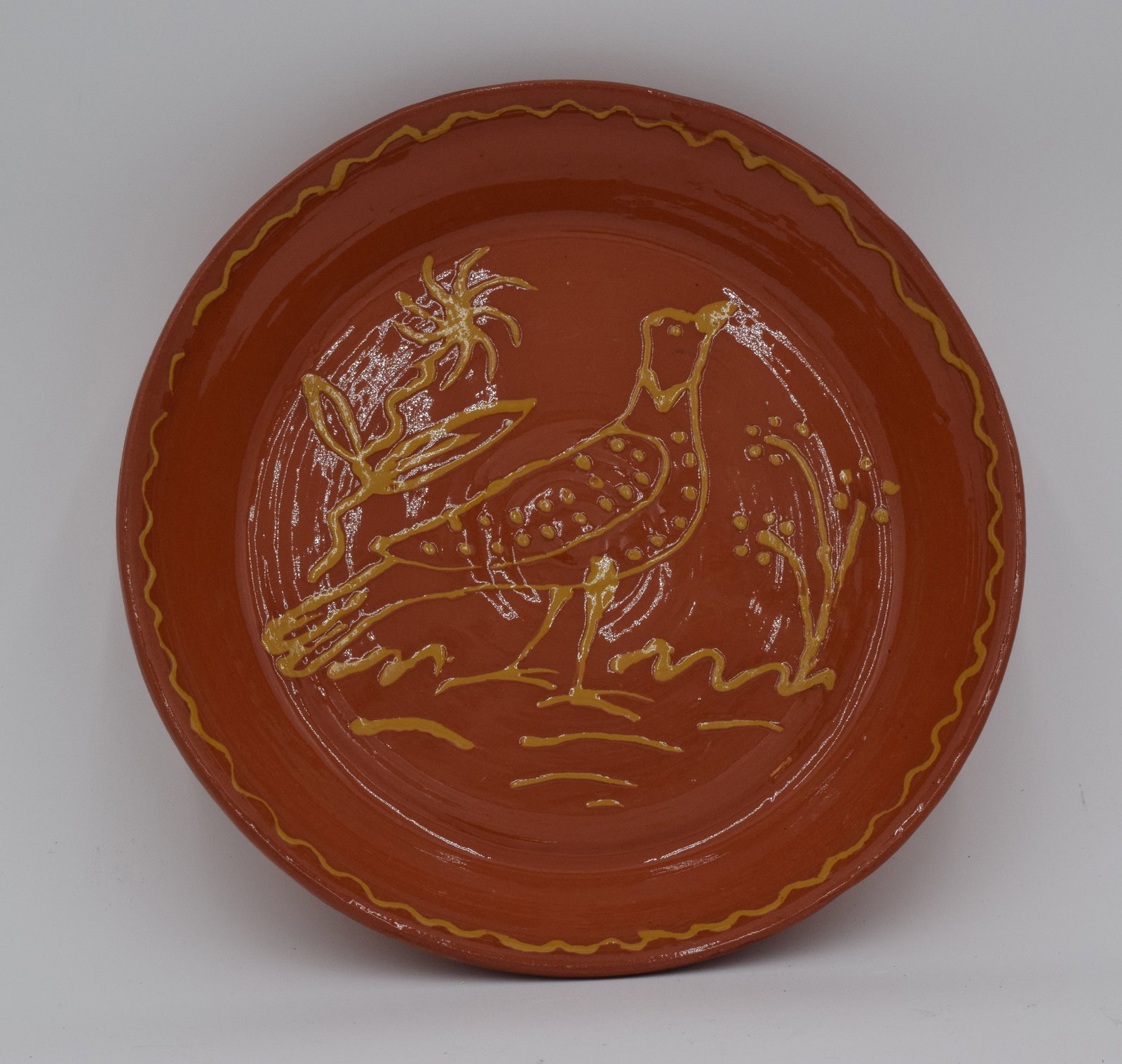 A. Vince Redware Plate With Bird c1982: Handmade. painted designs. PA Germans elevated redware from utilitarian household tools to works of art through the use of slipware and sgraffito decoration.