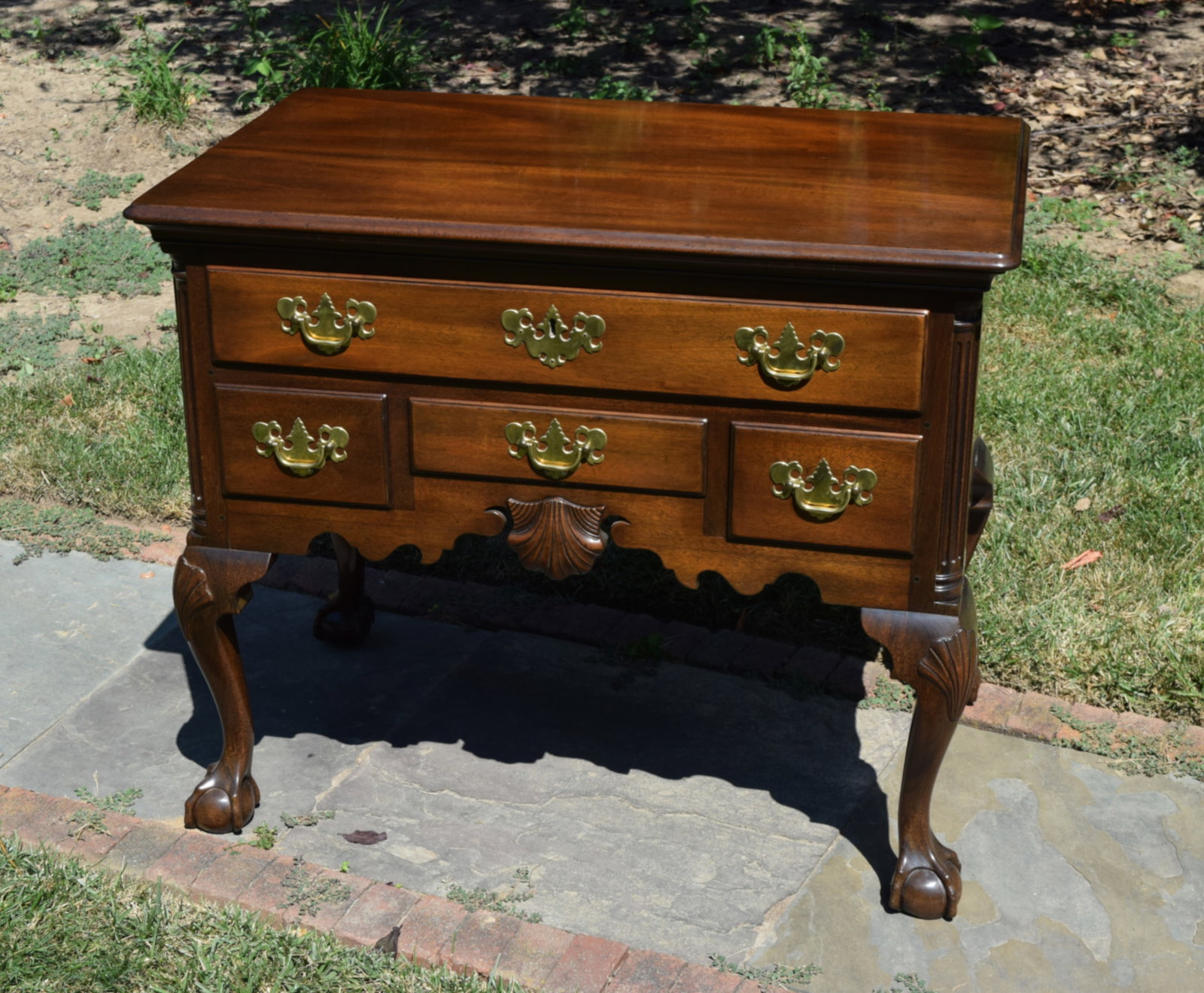 Kittinger T-2010 Chippendale Ball & Claw Lowboy: light heirloom finish with ball & claw feet. 18th century design with shell carvings.