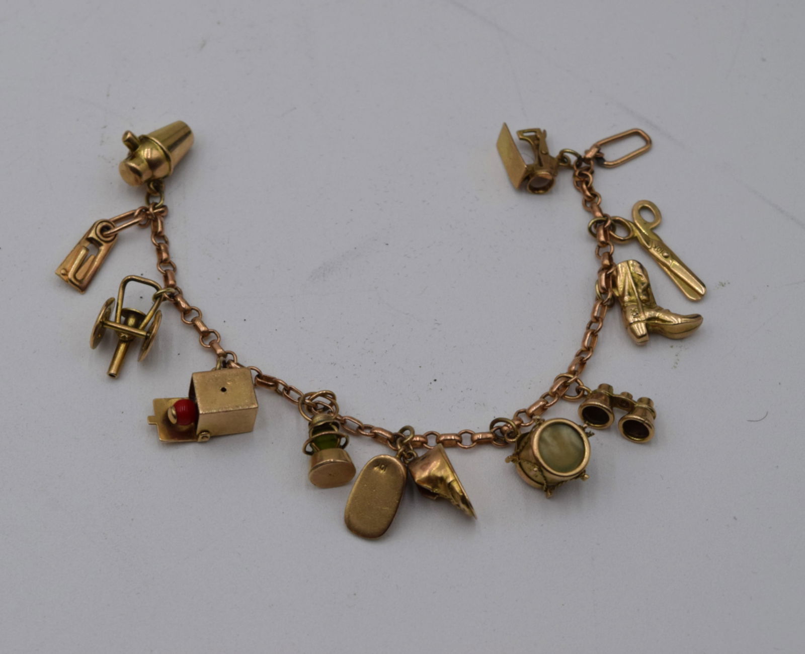 Vintage Gold 10-Charm Bracelet: Includes cannon, jack in the box, lantern, drum, boots, etc. 16.6 grams