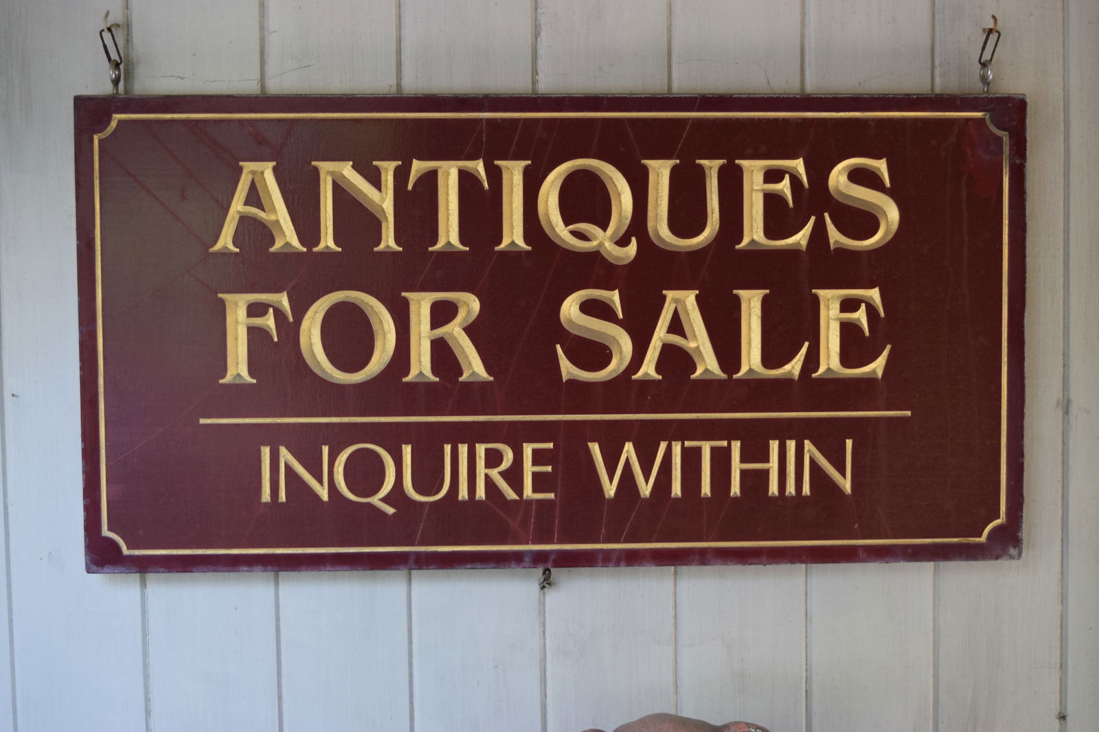 Large Wood Antiques For Sale Hanging Sign: Carved gold-painted lettering. Includes hanging hooks. Used by George Harrison for his Americana Furniture & Interiors business.