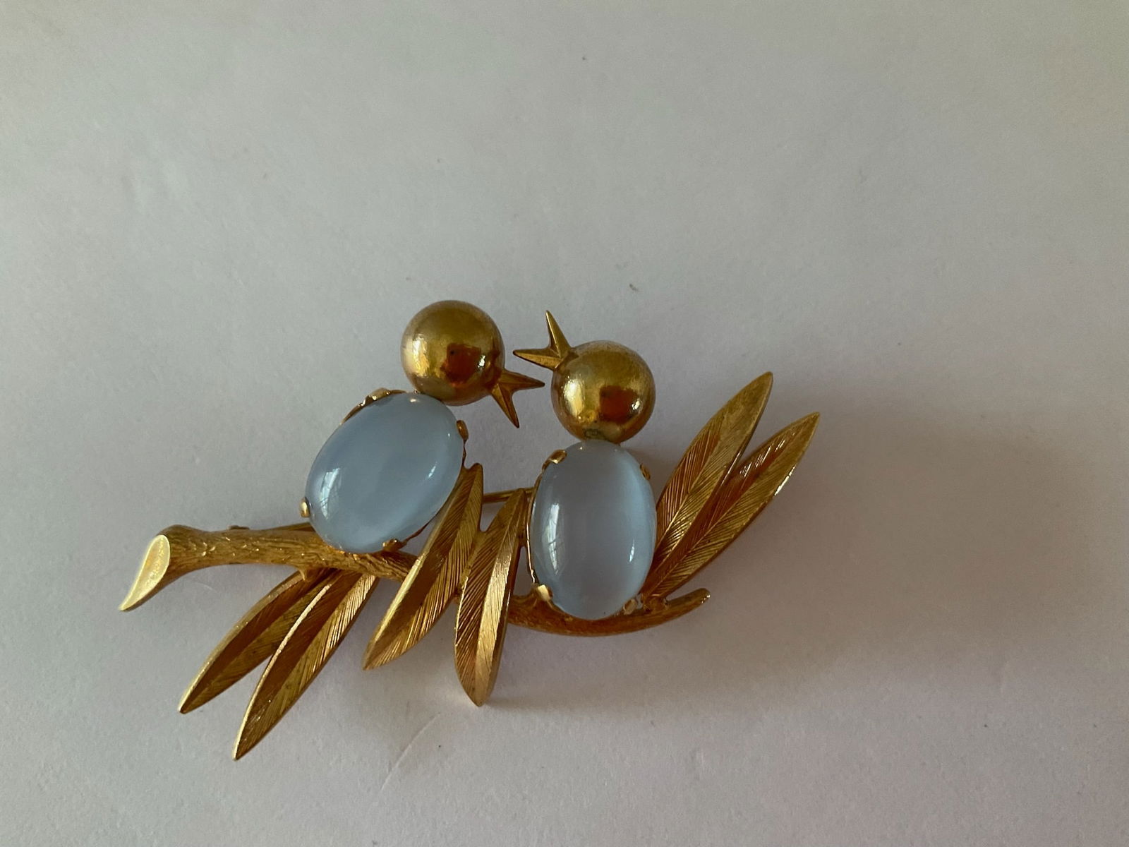 Vintage Mid Century Birds on a Branch Pin: This is a sweet gold tone metal brooch featuring two song birds sitting on a branch. The bodies of the birds are made up of moonstone like stones. The pin is 2.25 inches in width. Good vintage conditi