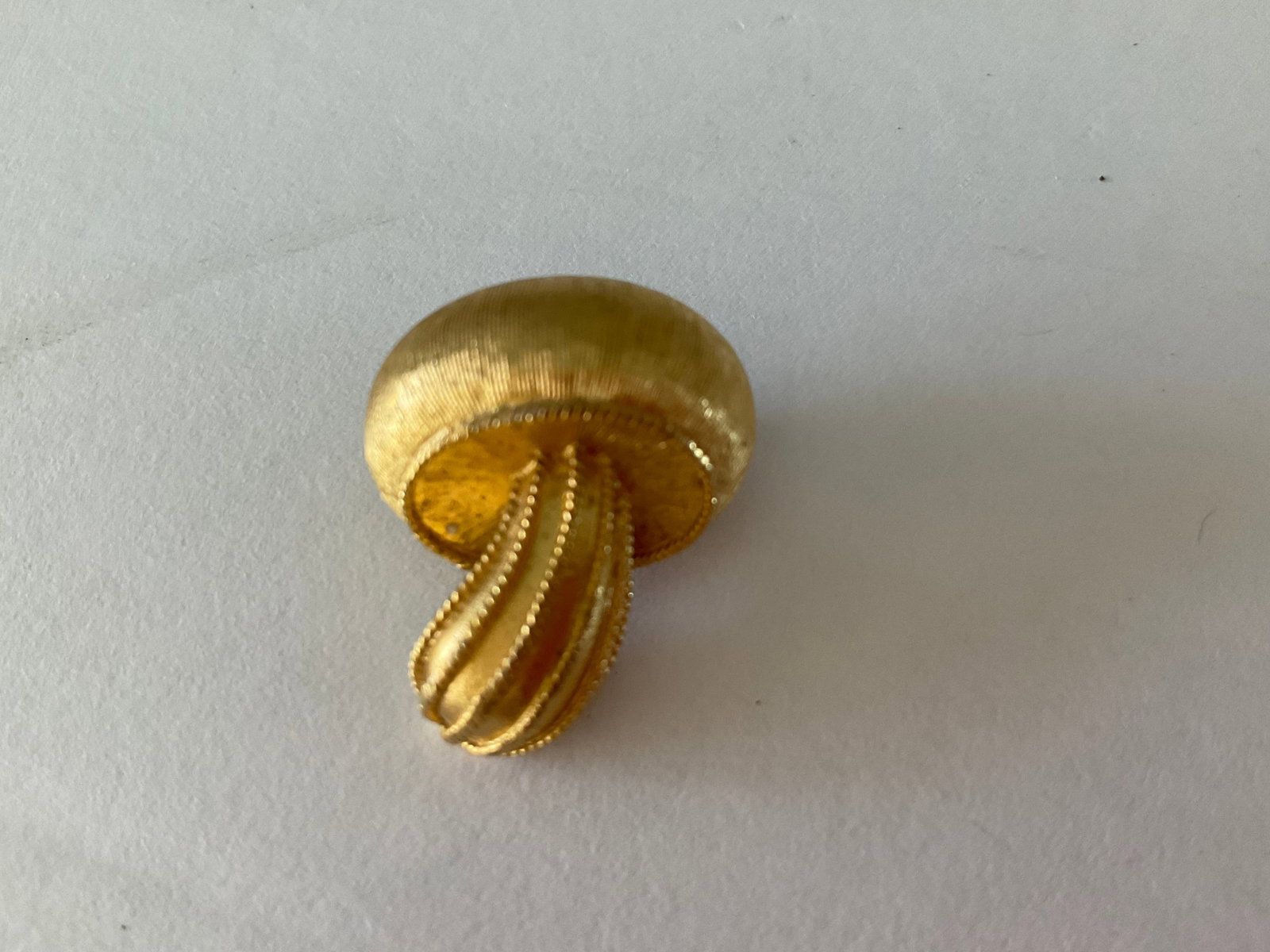 Adorable Trifari Vintage Gold Tone Mushroom Pin: An adorable vintage gold tone Trifari pin in the shape of a mushroom. It is in excellent condition and measures just under 1 inch.