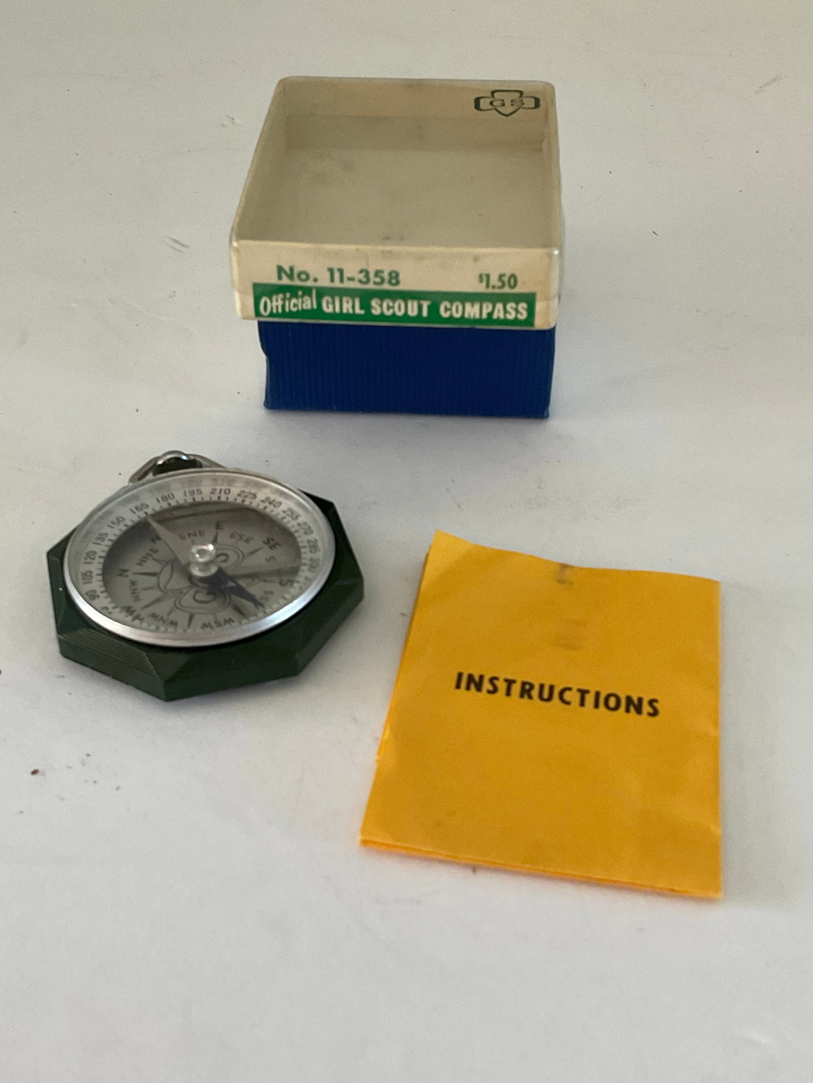 Vintage Girl Scout Compass in the Original Box: A vintage Green Girl Scout compass in the original box. It appears to be in working condition. The compass measures 2.5" x 2" and just fits into the box. It is model numner 11-358 made by Taylor Instr