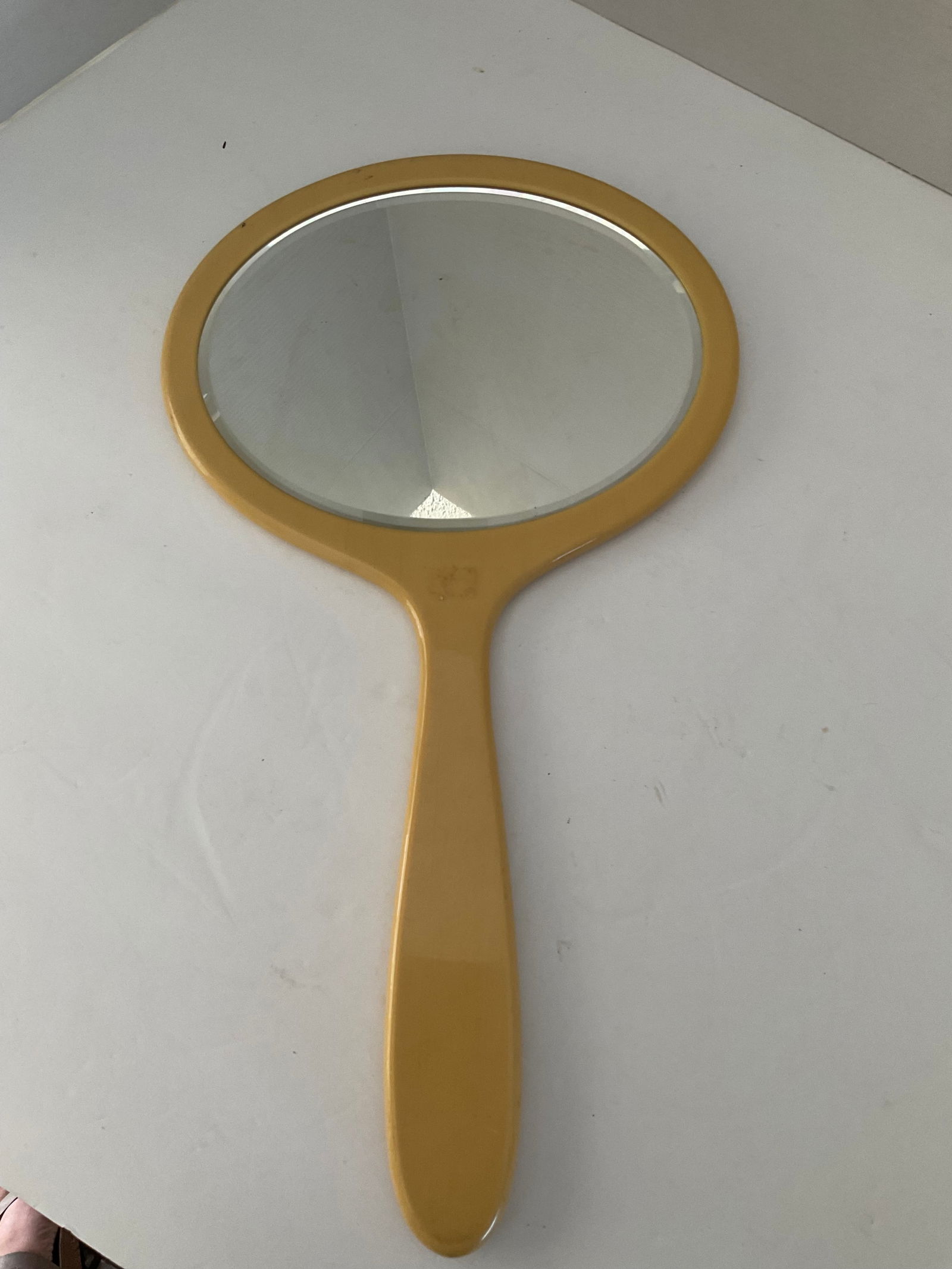 Vintage Celuoid (?) Hand Mirror, Oversized with Beveled Glass: A large hand mirror with beveled glass. It appears to be made from a yellowish celluoid. it measures 15.5 long and 9" wide. Good vintage condion with minor stains, see photos. Great addition to any va