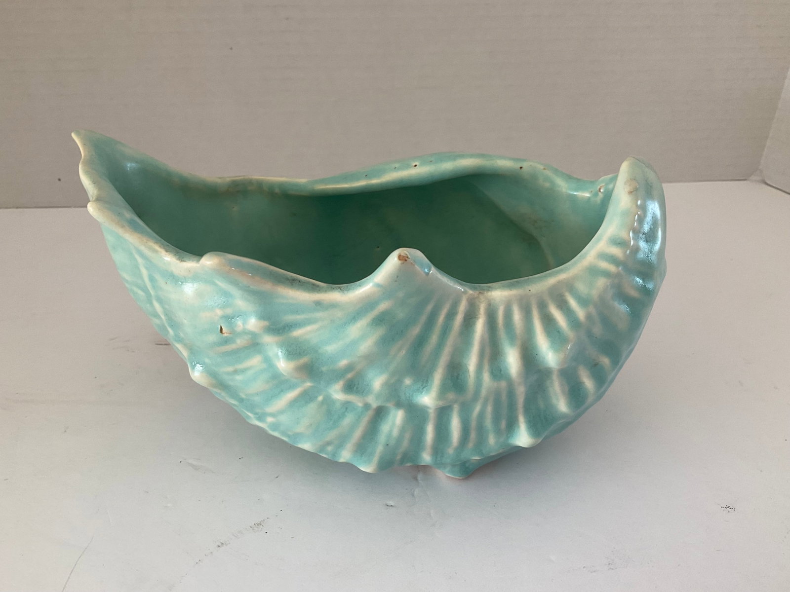 Vintage McCoy Aqua Shell: A vintage aqua McCoy shell shaped planter. This piece is is approximately 5 x 8 inches. One minor chip to one spike edge. Unusually marked to the base. Please see photos