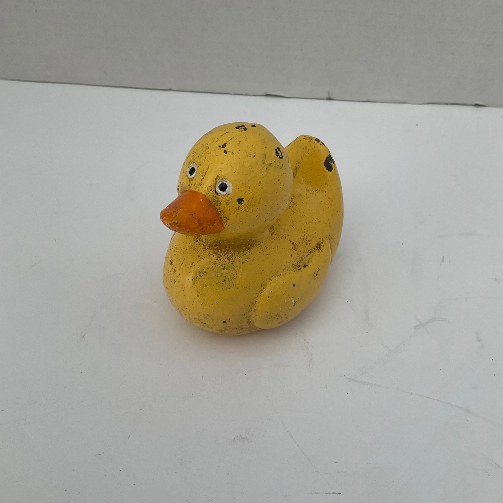 Vintage Cast Iron Duckie: A rare painted cast iron "rubber duckie" . It has a bit of paint loss, please see photos. It measures 3"h x 3.5"
