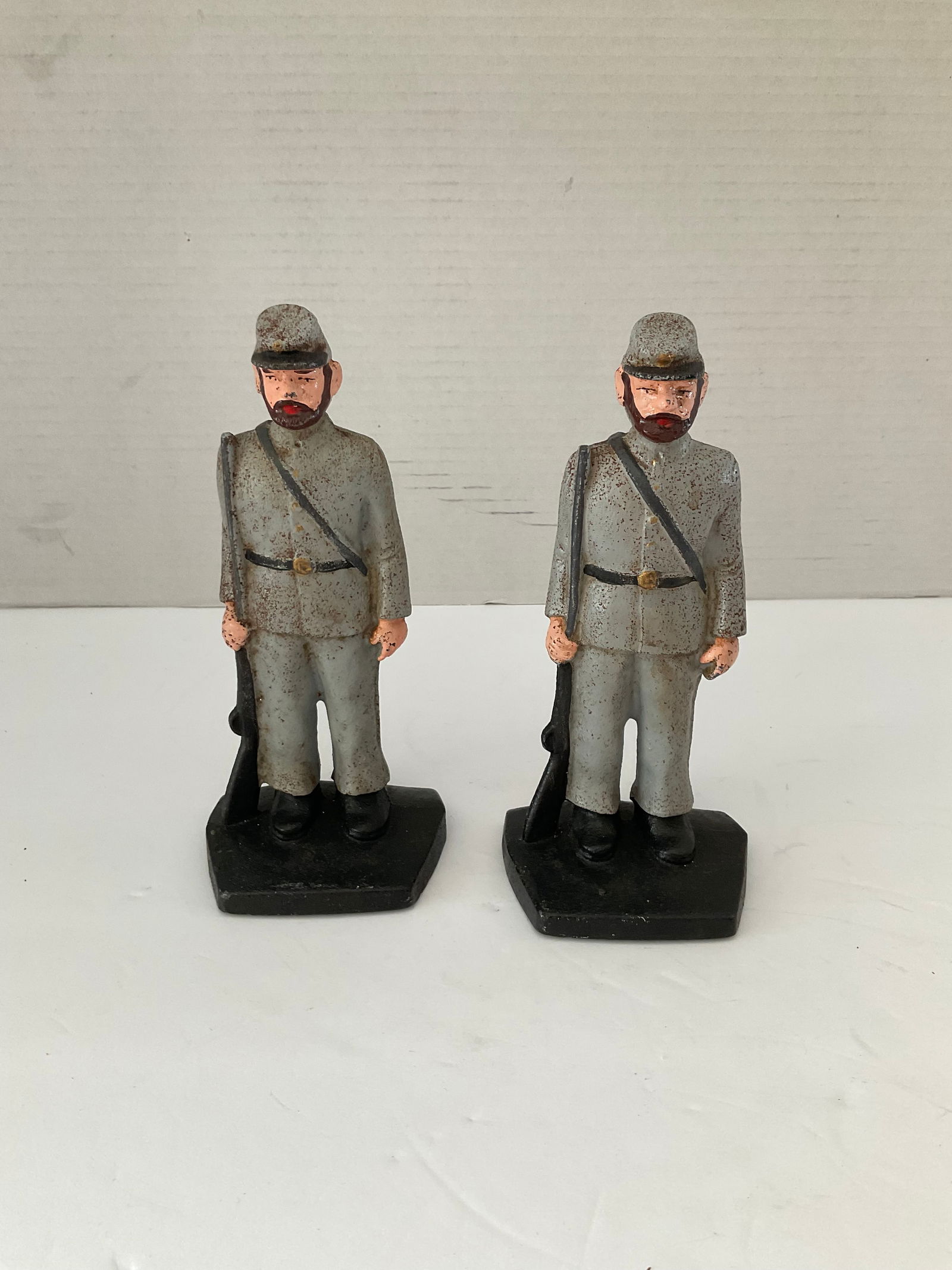 Antique Cast Iron Soldier Themed Doorstop/Bookend Pair: A pair of cast iron Confederate Soldier themed bookends or doorstops. These pieces appear to have the original paint. Each is 7.5" in height