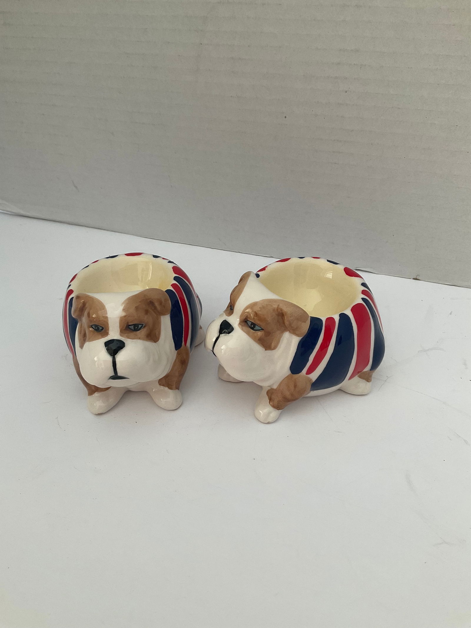 Pair of British Bulldog Egg Cups: A pair of ceramic British bulldog egg cups. Good condition. Each is approximately 4 x 3”