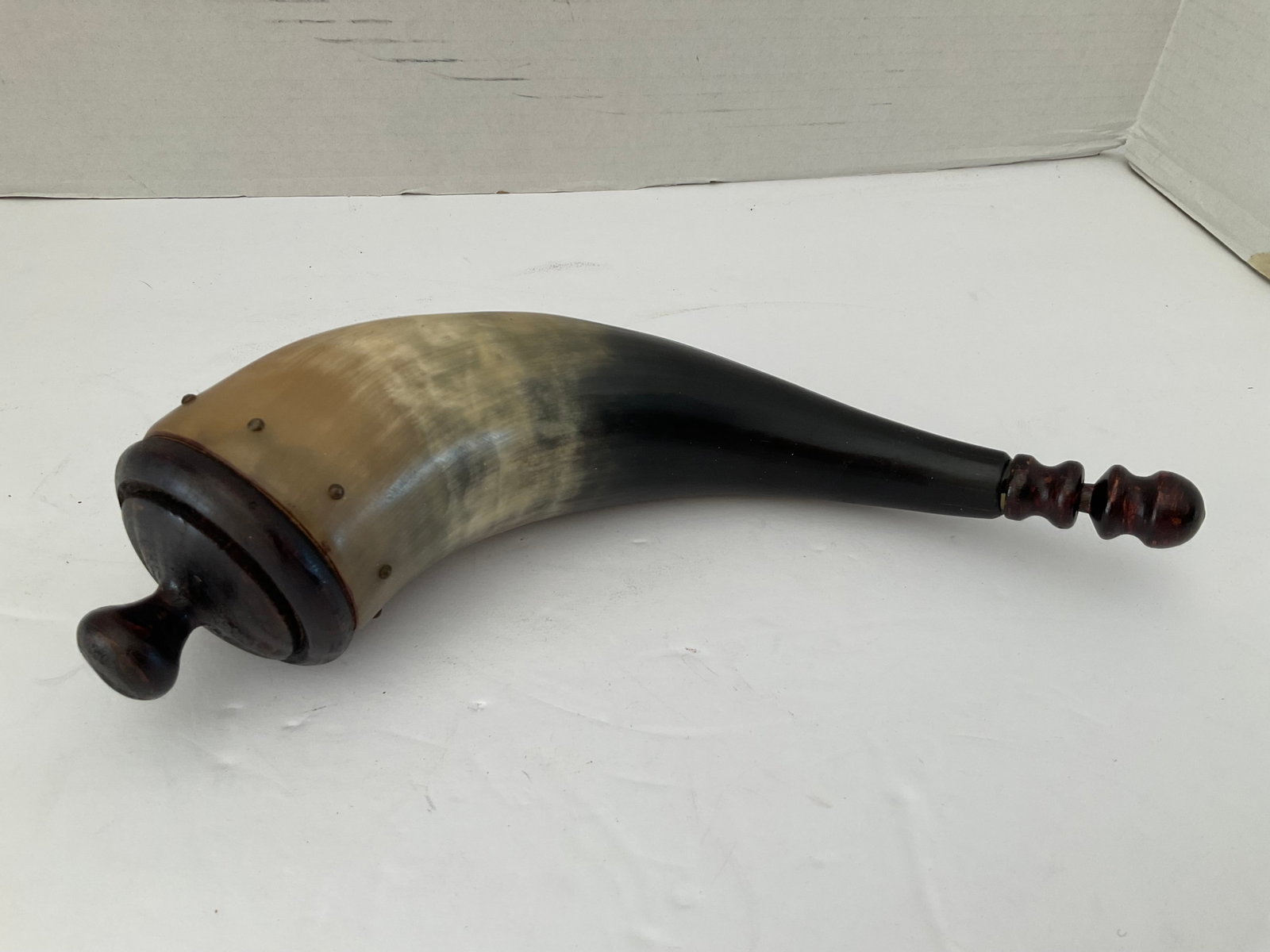 Antique Powder Horn: An antique powder horn with wood accents. 10" in length. Small end opens and works well. Please see photos