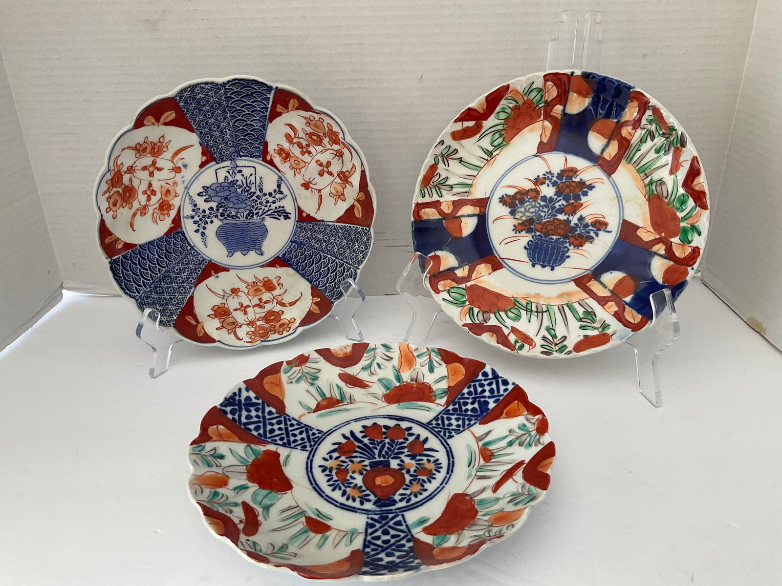 Three 19th Century Imari Plates with Basket Theme: A trio of antique Imari 8.5" Plates. Each features a center medallion of a cobalt basket. Good vintage condition. Please see photos.