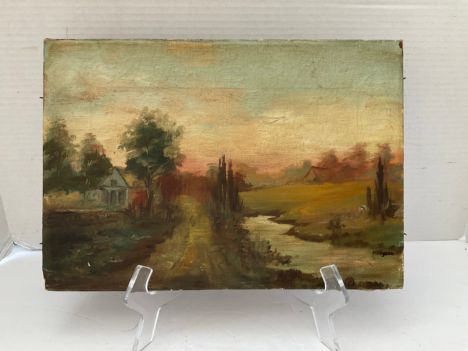Antique Oil on Canvas Signed MB Tyson: An antique rural landscape singed MB Tyson to the lower right in paint. Unframed, it measures 9 x 13". Small hole located to the center of one of the treetops. Could use a good cleaning. Please see ph