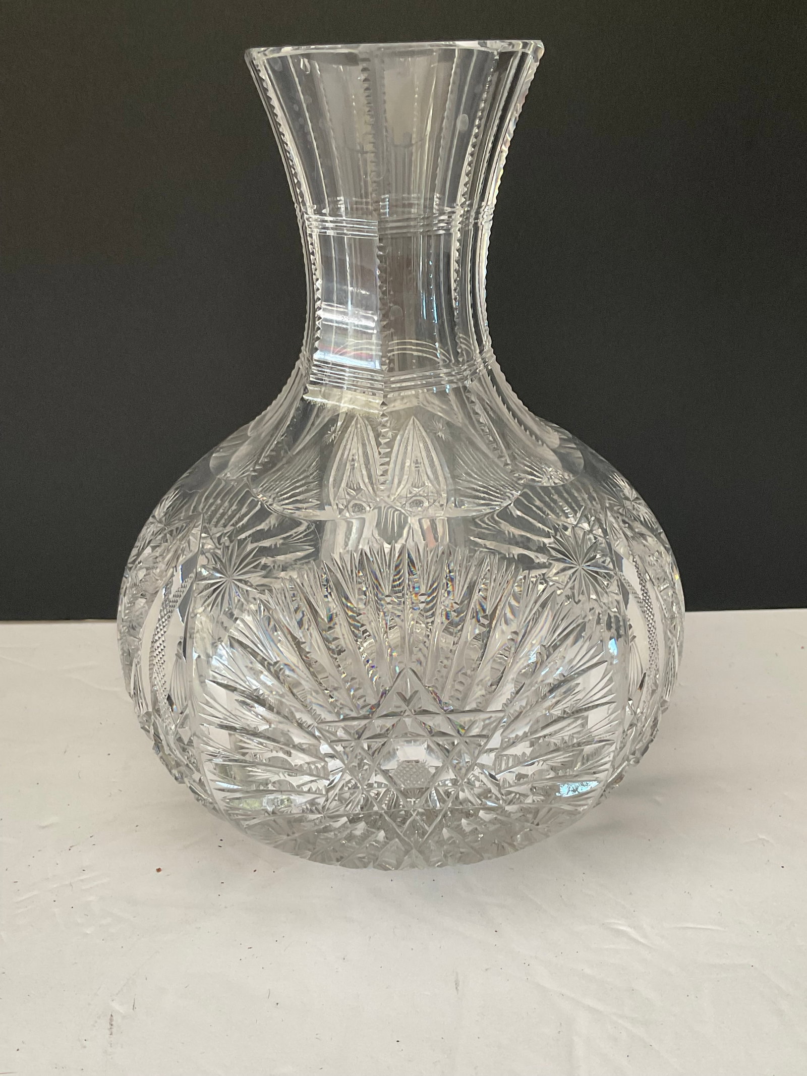 ABP Antique Cut Glass Water Carafe: An American Brilliant Pattern cut glass carafe. This lovely piece has multiple fans and hobstars. It measures 9"h and 7" in diameter.