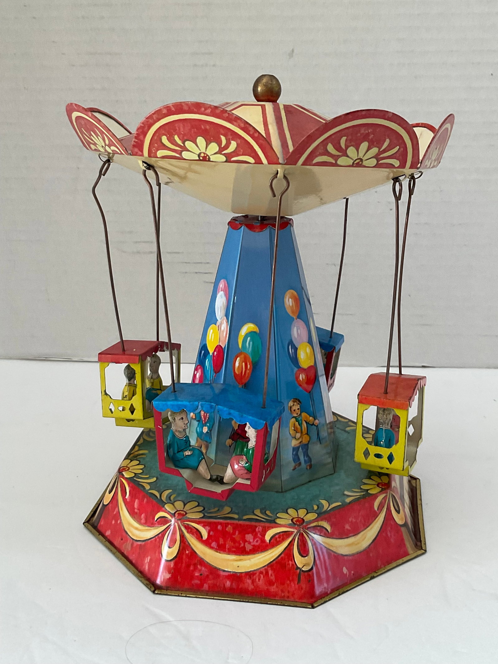 Vintage Tin Toy Carousel made in Germany: A vintage reproduction tin toy. This is a sort of carousel with flying seats. It works with some adjustments needed. Made in Germany 2002, by JW Company. Clear colors, no fading. 8"h x 6" diameter