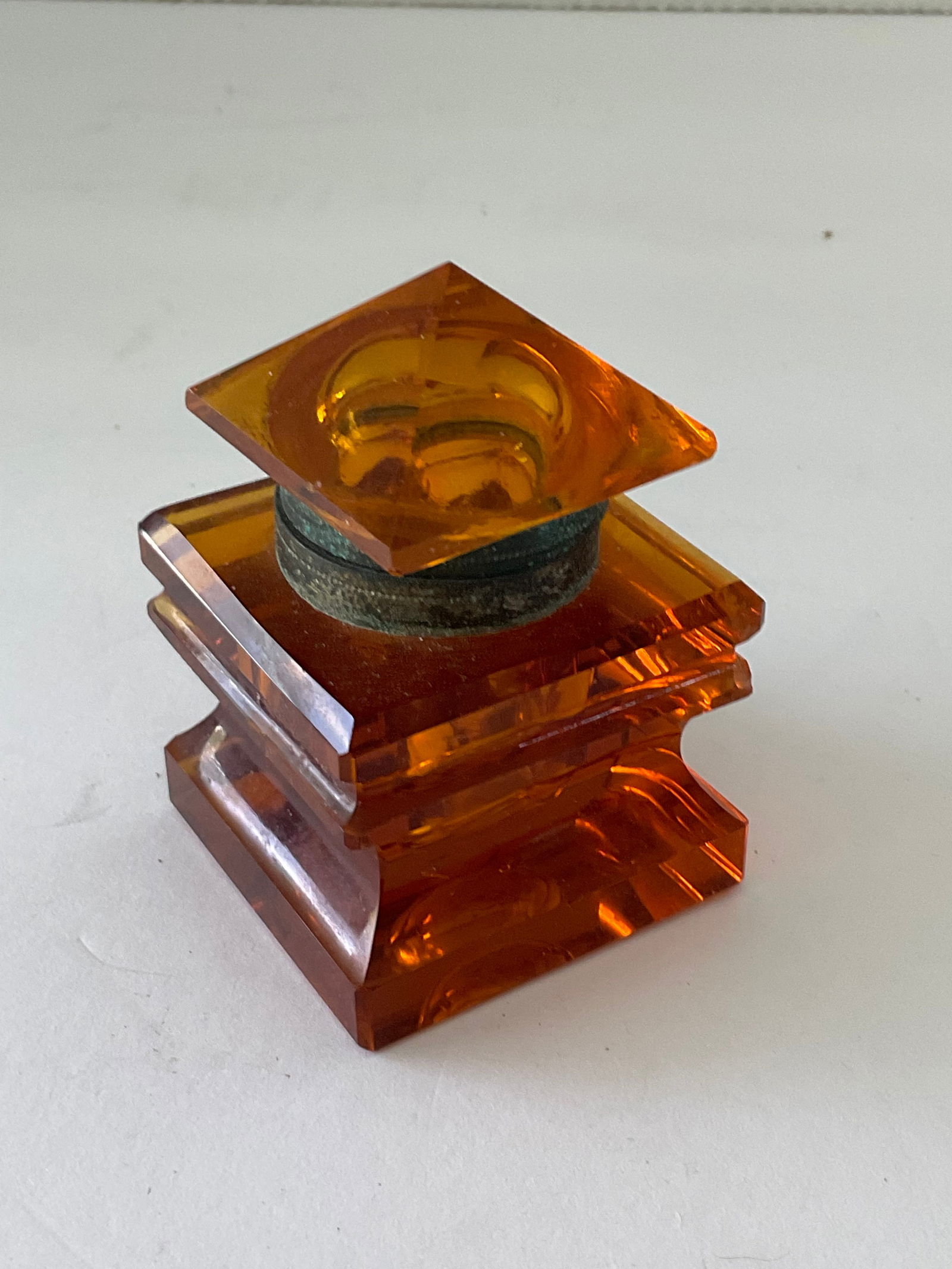 Victorian Amber Glass Inkwell: An antique Victorian Edwardian amber glass inkwell. This piece has a hinged top and a square shape. It measures 2" square and just under 3" in height.