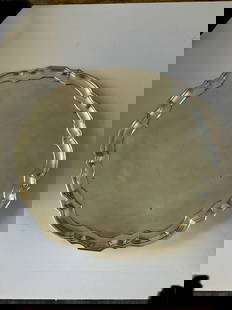 Sterling Silver Platter Stamped Tiffany & Co: A Tiffany & Co Solid Sterling round platter with scalloped edge. This piece is stamped "Tiffany & Co Sterling" to the underside. 12" in diameter, 938.9 grams.