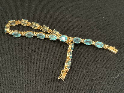 14k Yellow Gold, Diamond and Aquamarine Tennis Bracelet: A 14k yellow gold, diamond and aquamarine (untested) tennis bracelet. Stamped 14K to the clasp. The stones are faceted oval shape. 7.5" and 10.3 grams.