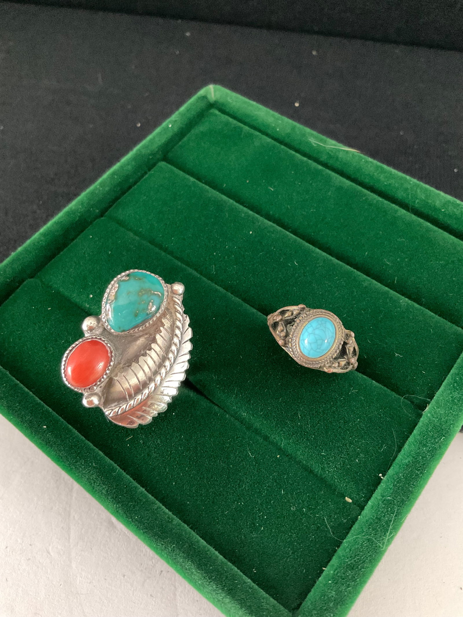 Two Vintage Sterling Southwestern Rings: Two vintage Sterling rings, both with turquoise and one with both turquoise and coral. The smaller is size 5.5 and the feather ring is size 7. Combined weight is 13.3 grams