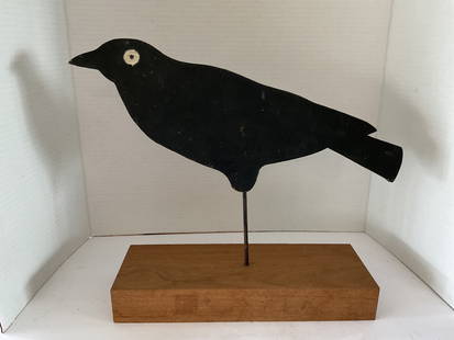 Early Navajo Primitive painted Wooden Crow on Plinth: An early 18th Century Navajo painted crow. This piece is set on a metal rod attached to a modern wood plinth. The wood crow is painted black - original paint- with a white eye. It is 13"h x 15"w x 4"d