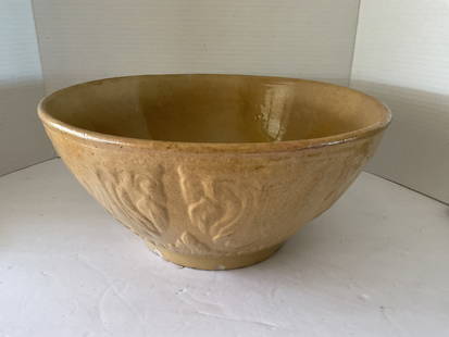 Antique Yellow Ware Mixing Bowl: Antique Yellow Ware mixing bowl measuring 12 inches in diameter and 6 inches in height. It has a raised design and is quite thin. Small chip to the lip and a chip to the bottom edge. Believed to be a
