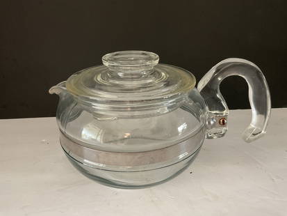 Mid Century Pyrex Tepot: A mid century glass Pyrex teapot with chrome accents. It measures 5.5"h x 8" at the handle. 6 cup capacity, fire symbol to the base