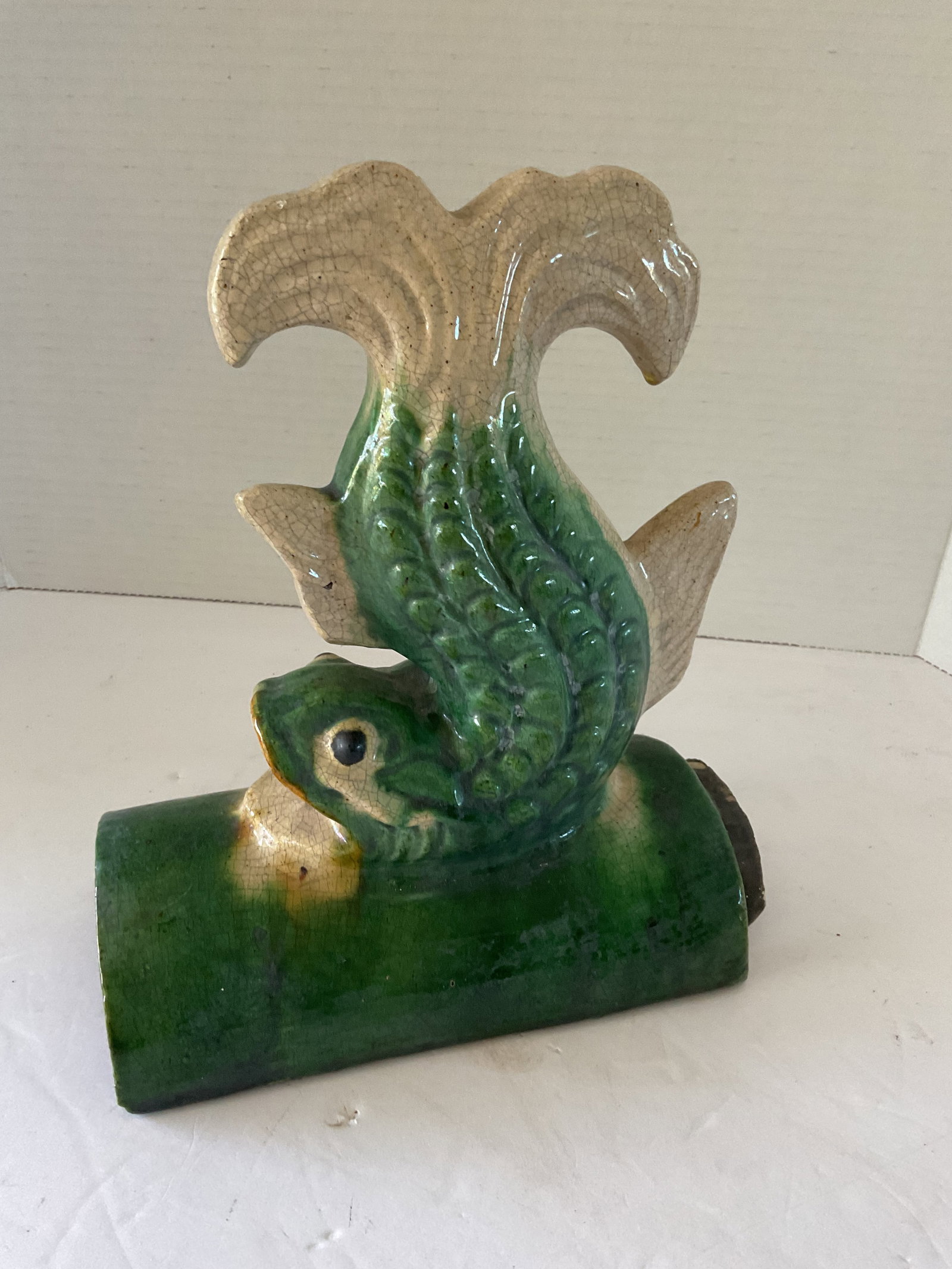 1900's Dolphin Roof Tile: An antique dolphin fish roof tile. It has crazing a a few chips to the underside. Still has amazing colors and great form. It measures approximately 10"h x 8.5" x 4". Please see photos. Rare find!