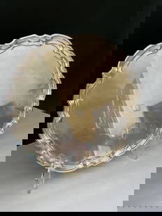 Tiffany & Co Sterling Silver Platter: A Tiffany & Co Solid Sterling round platter with scalloped edge. This piece is stamped "Tiffany & Co Sterling" to the underside. 12" in diameter, 938.9 grams.