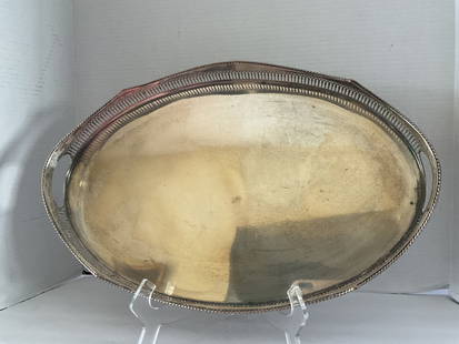 Vintage Silverplate Serving Tray: A vintage silver over copper serving tray. This piece has rounded button feet and reticulated edge. It measures 18" x 12" x 2.5"
