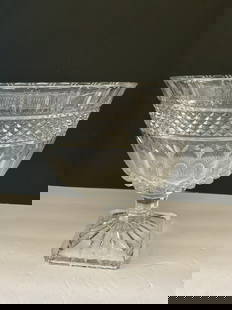 Antique Flint Glass Compote: An antique flint glass compote. This piece has a beautiful ring to it. Some minor chips shown in photos. It is 10"h x 10" in diameter. Beautiful centerpiece.