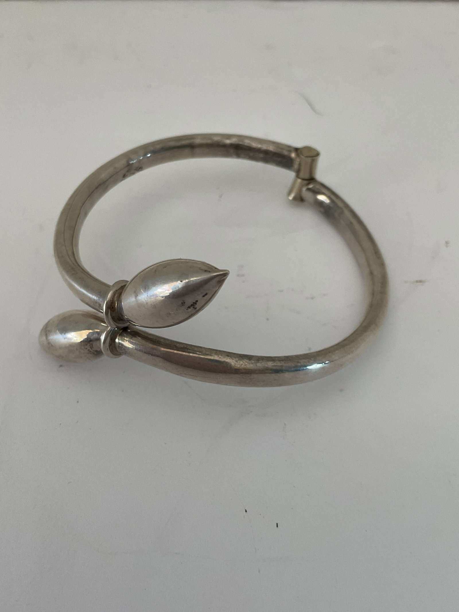Sterling Silver Bracelet: A vintage hinged stamped sterling bracelet made in Mexico. The bracelet has a closed diameter of 2.5".