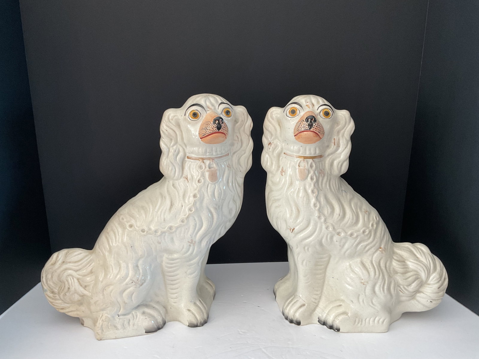Pair of Full Size 19th Century Staffordshire Mantle Dogs: A pair of 19th century Staffordshire Mantle Dogs. Traditional spaniel design each measuring 13" x 10 x 4". Minor Hairline cracks made long ago, shown in photos. Some paint loss