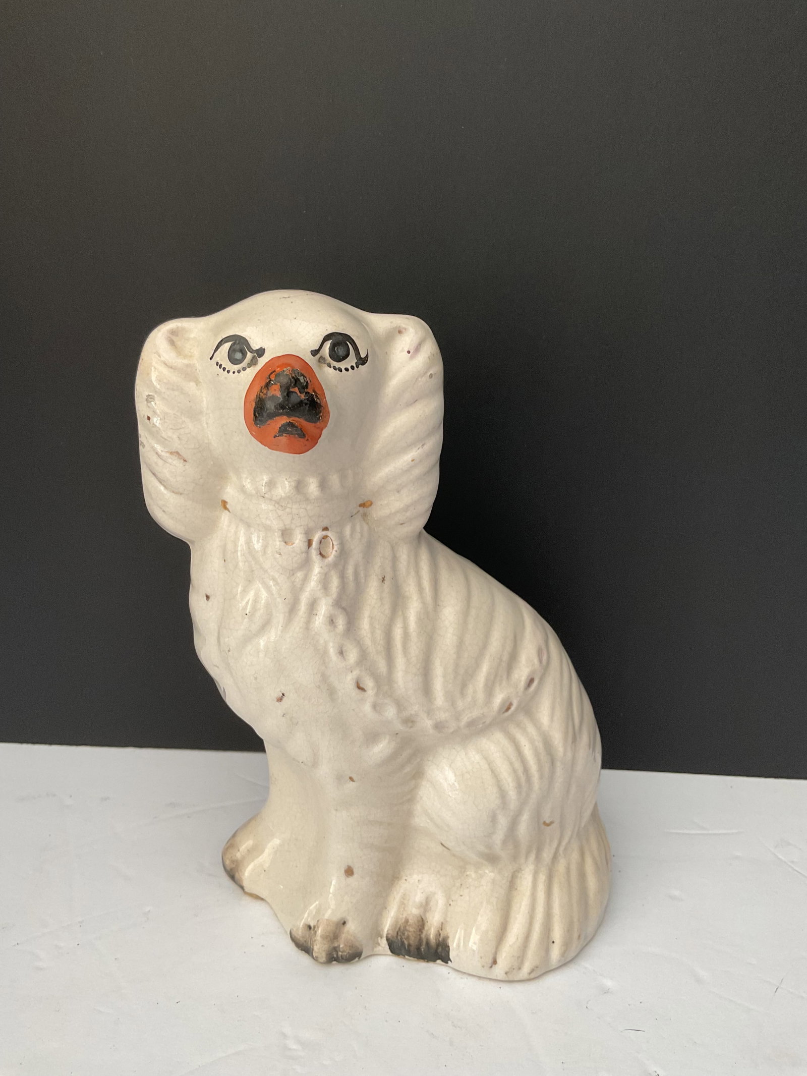 19th Century Staffordshire Mantle Dog: A medium size (8"h x 5' x 3") antique Staffordshire Mantle dog. Unmarked, nice wear to the base, some paint loss. Please see photos
