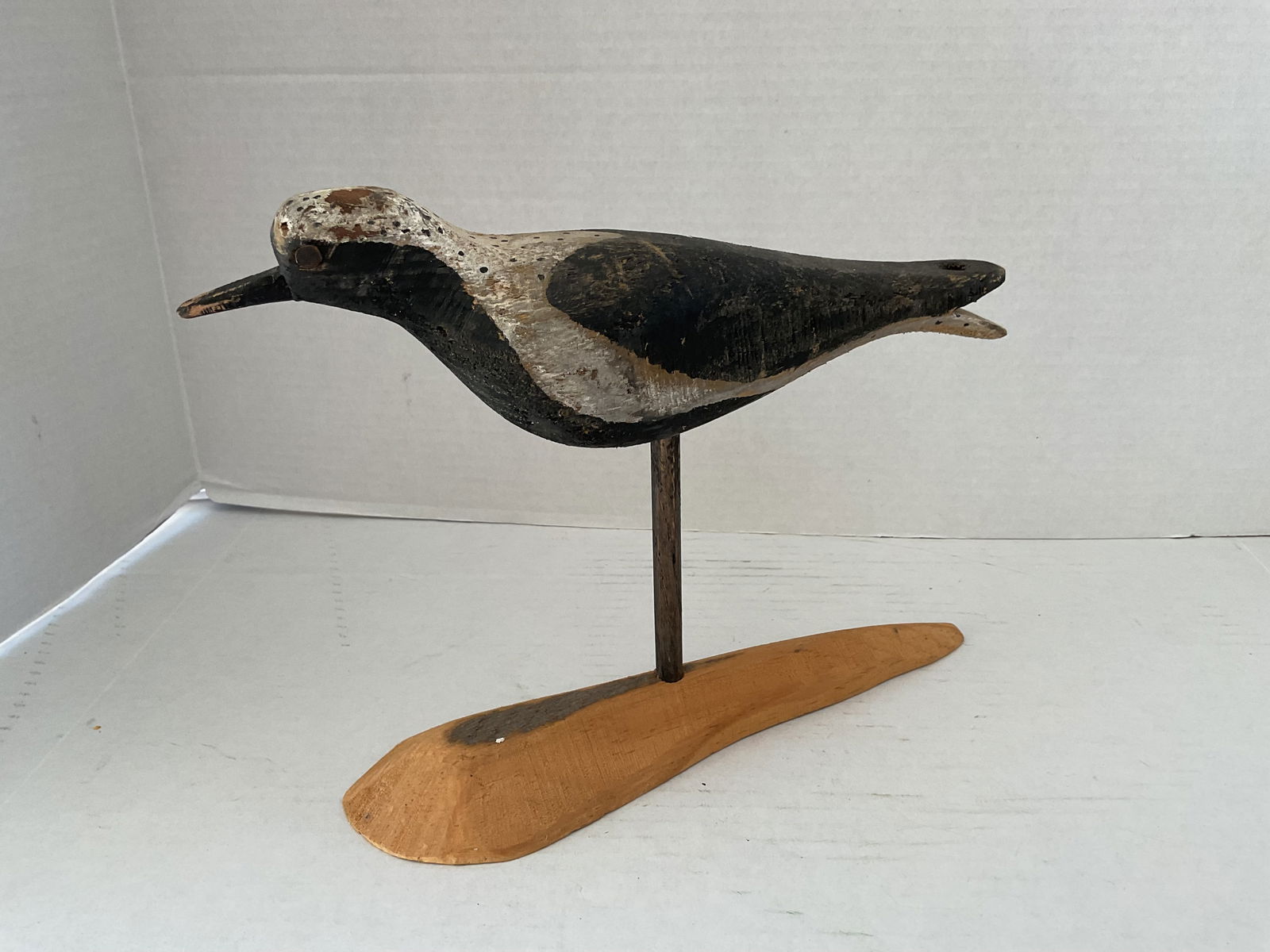 Hand Carved Mid 20th Century of a Black Breasted Plover by D.A. Kaufman.: A mid century hand carved Black Breasted Plover. It shows wear consistent with age, eyes are metal tacks. It is signed by the artist to the underside of the stand "DA Kaufman, E. Weymouth Mass" it is
