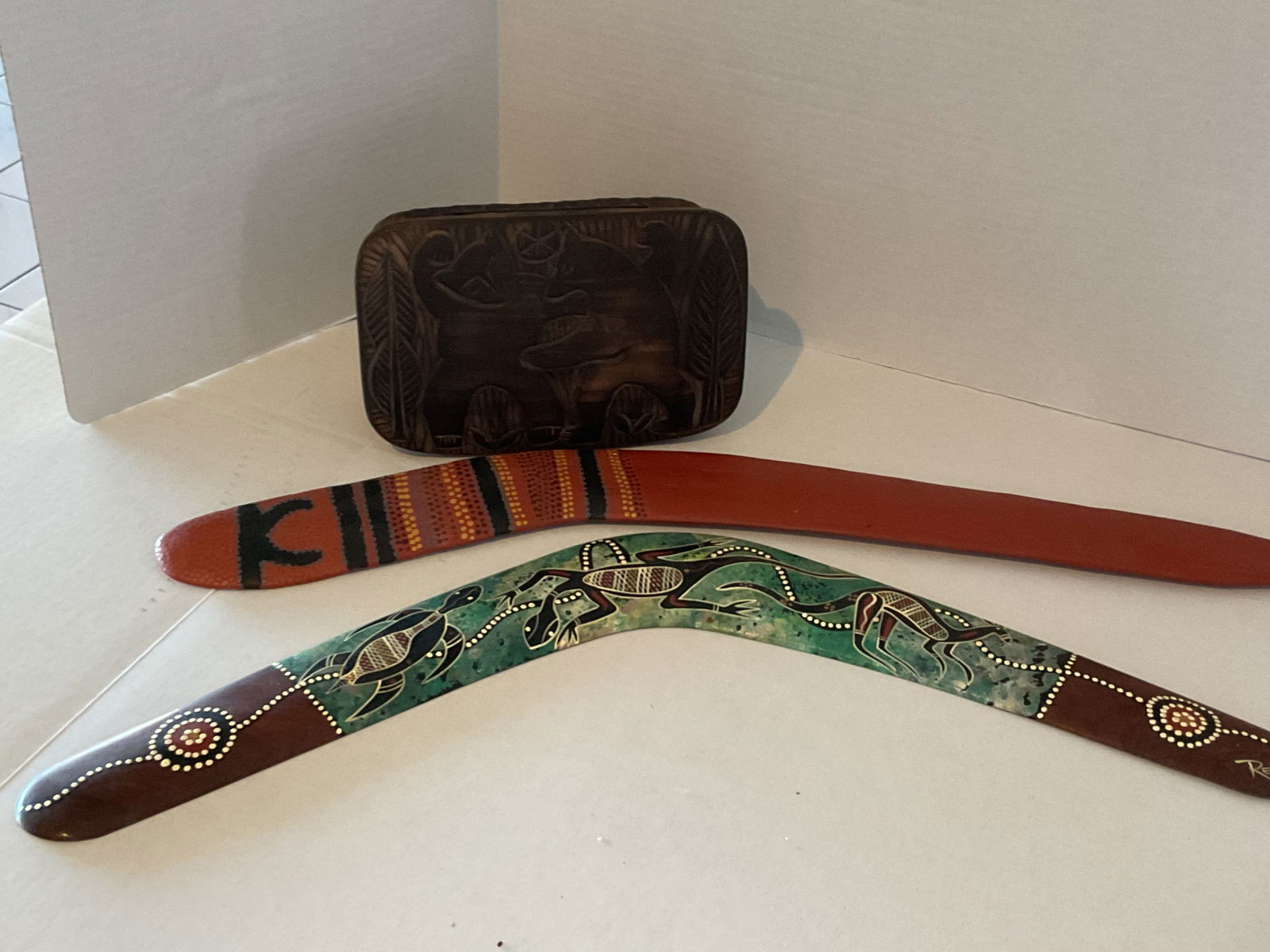 Two Australian Aboriginal painted Wood Boomerangs and Carved Wood Box: Included are two Australian Aboriginal decorated boomerangs (one signed as shown in the photos). Also included is a carved wooden box. The boomerangs are approximatey 23" in length and 2" wide, they a
