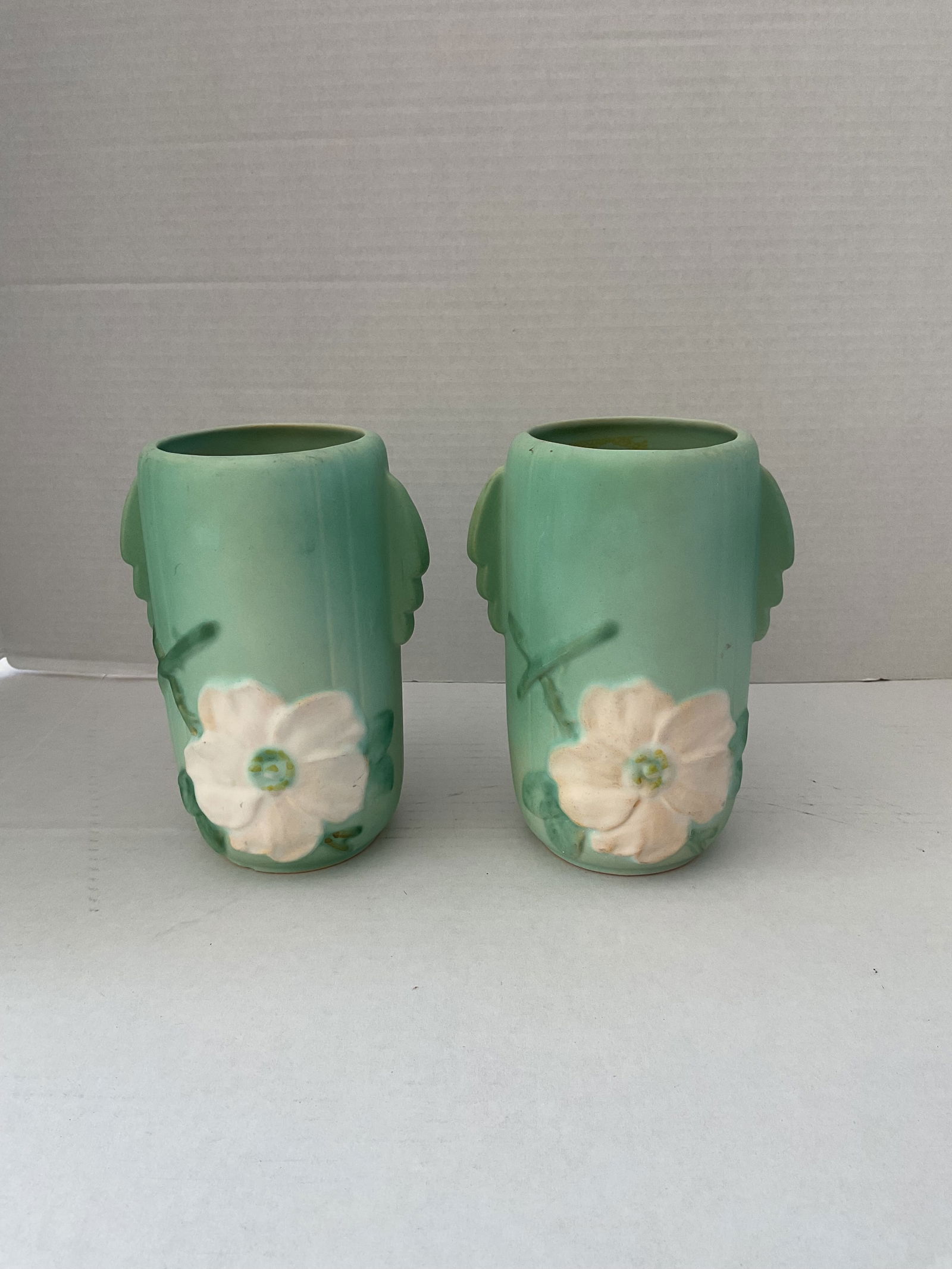 Pair of Vintage 1930's Wild Rose Weller Vases: A pair of Weller vases in the wild Rose pattern. Each is just over 7" in height and 4" in diameter.