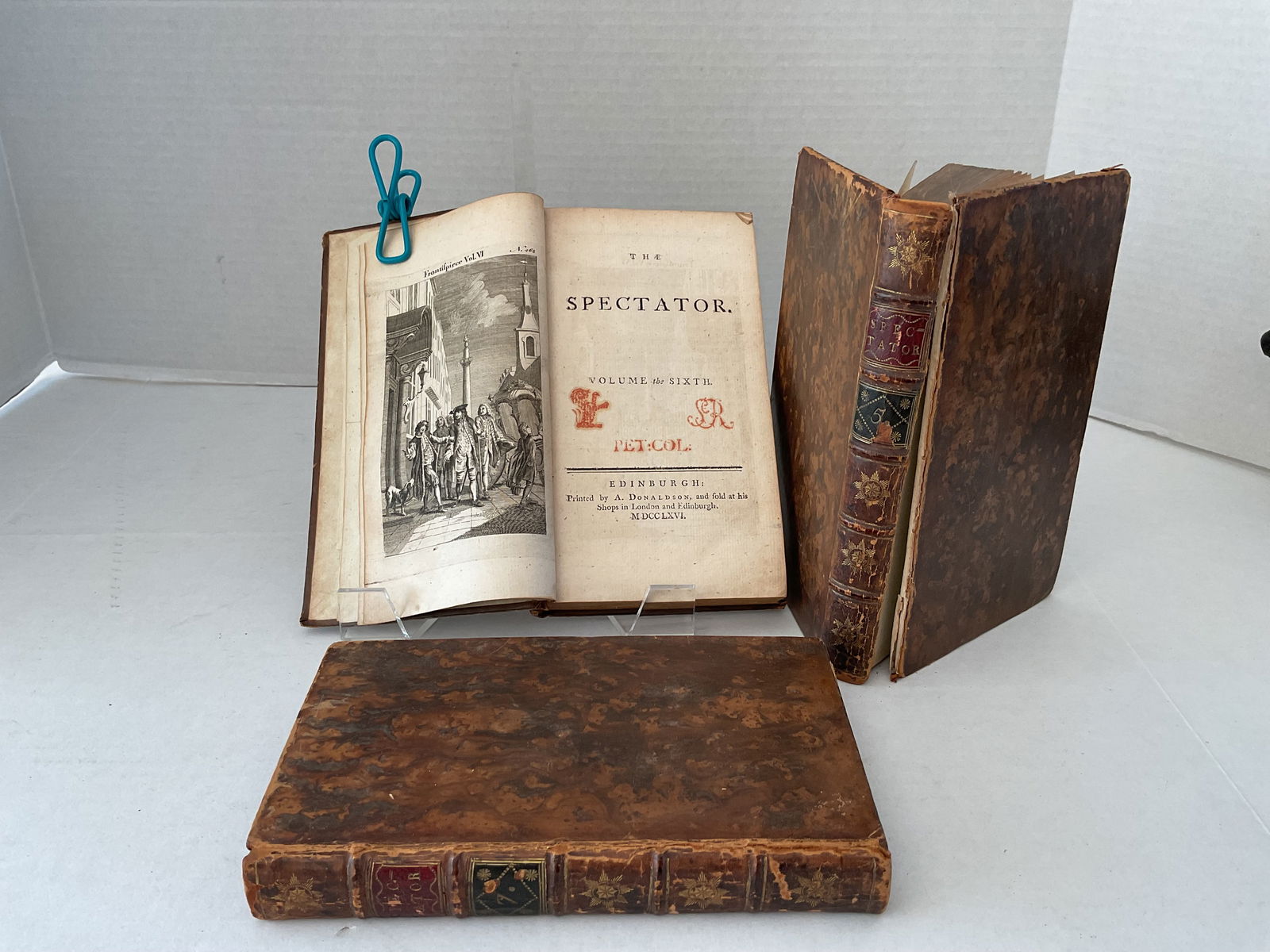 Three Antique Volumes (5,6 and 7) "The Spectator" Printed in 1766: A collection of three volumes of "The Spectator". Published in Edinburgh in 1766. Each of the editiopns have engravings to the front page. They are leather bound - some wear to the edges and one front