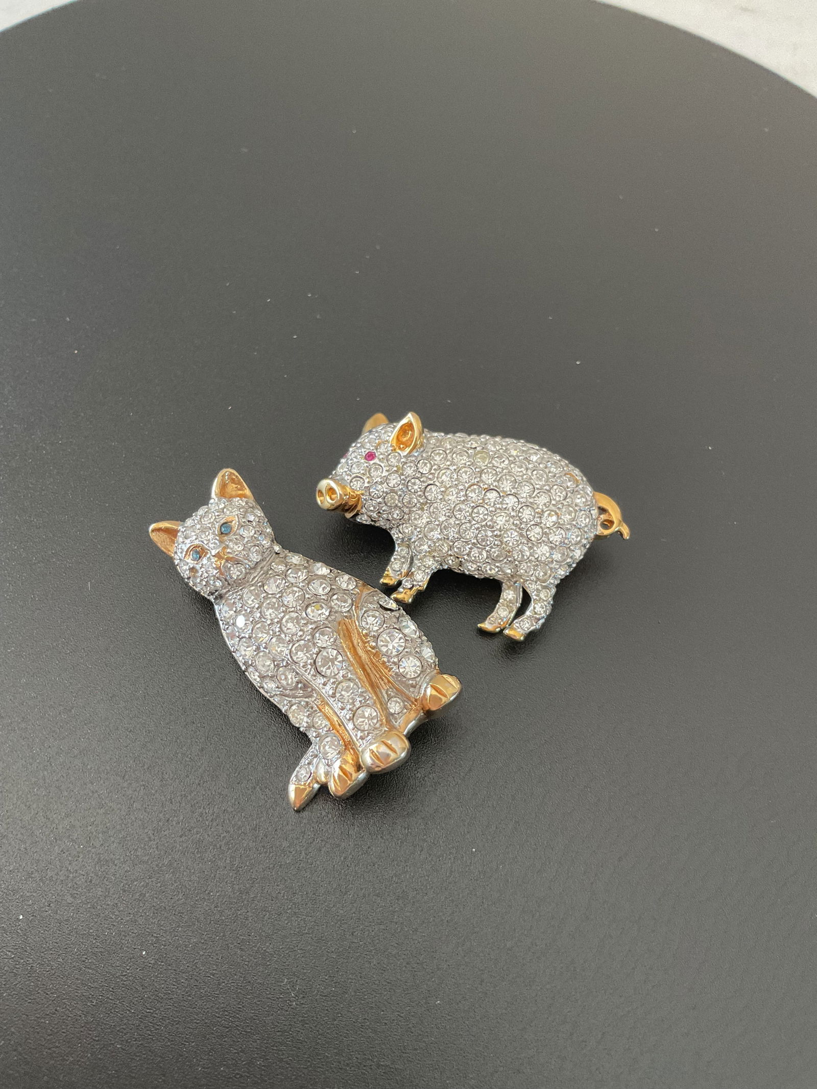 Vintage Signed Carolee Crystal Animal Pins: Two Carolee crystal brooches. Included is a standing pig and a seated cat. The cat is missing one crystal on its face. Each is approximately 1.5".