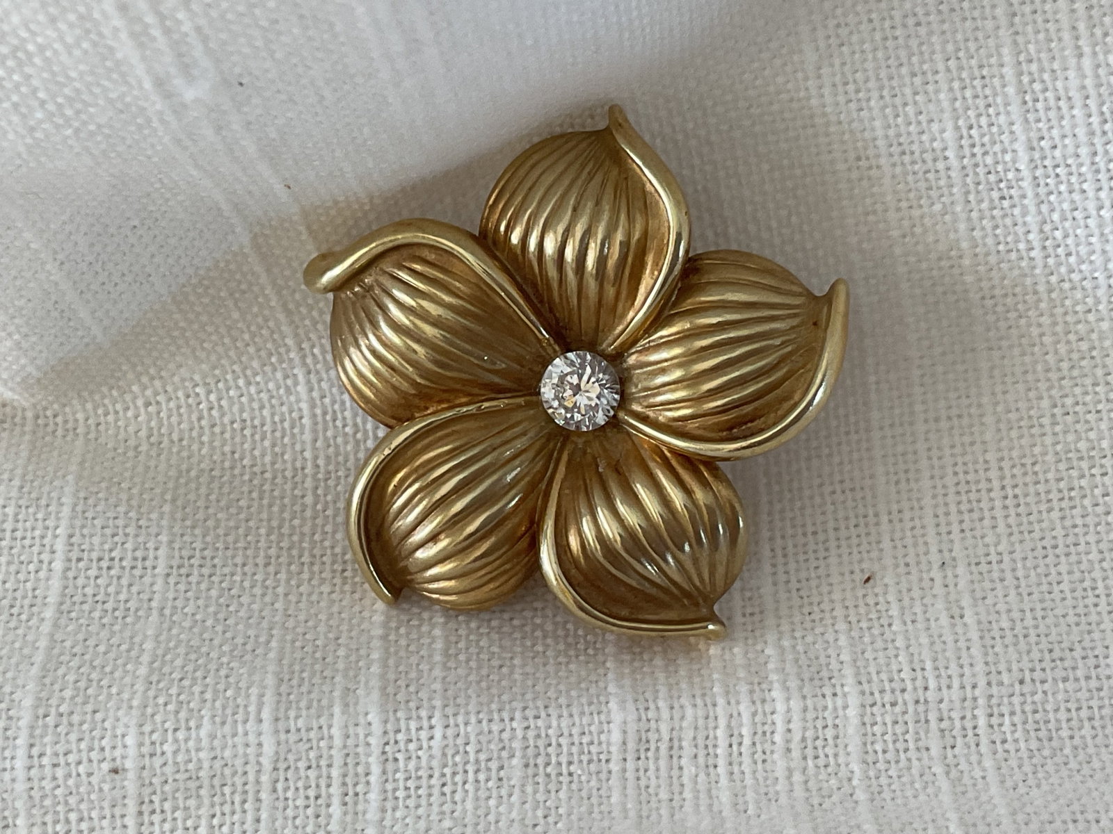 14K Yellow Gold Frangipani Blossom Pendant/Brooch: A lovely 1.5" 14K yellow gold frangipani brooch/pendant. Clearly stamped, center stone has not been tested. Weight is 4.9 grams
