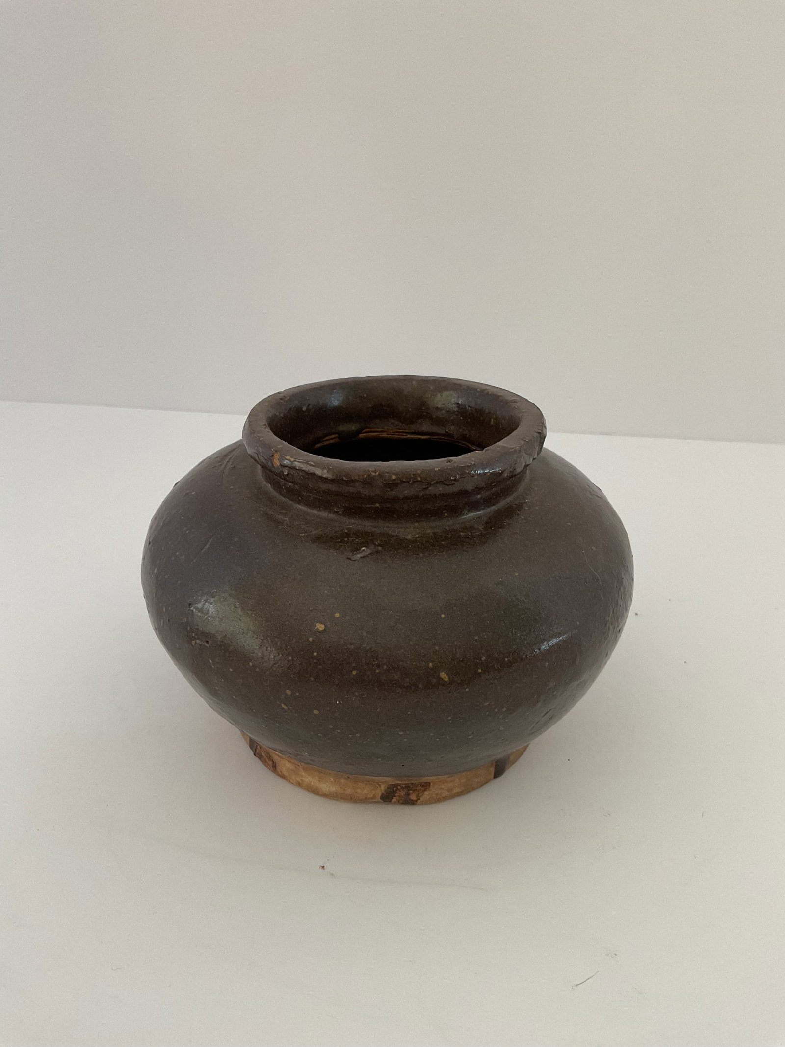 Qing Dynasty Condiment Pot: A Chinese condiment or soy sauce pot circa 1800. Qing dynasty (1644-19120. This is a sturdy pot with a dark brown glaze and a utilitarian shape. It measures approximately 4 x 5". Good cond