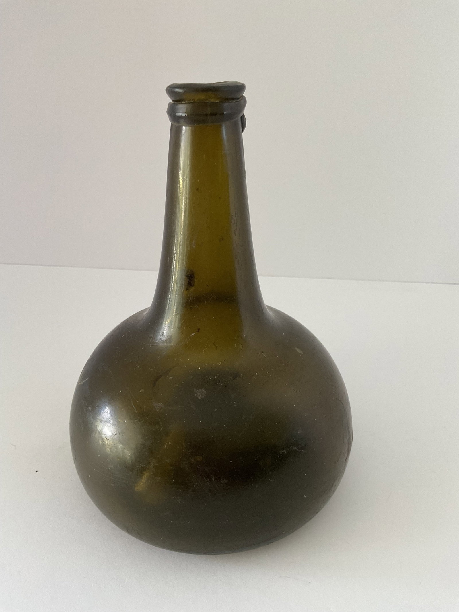 Antique Hand Blown Onion Bottle: An antique onion or chestunt bottle most likely for wine, hand blown. It measures 8"h x 5.5" in diameter.