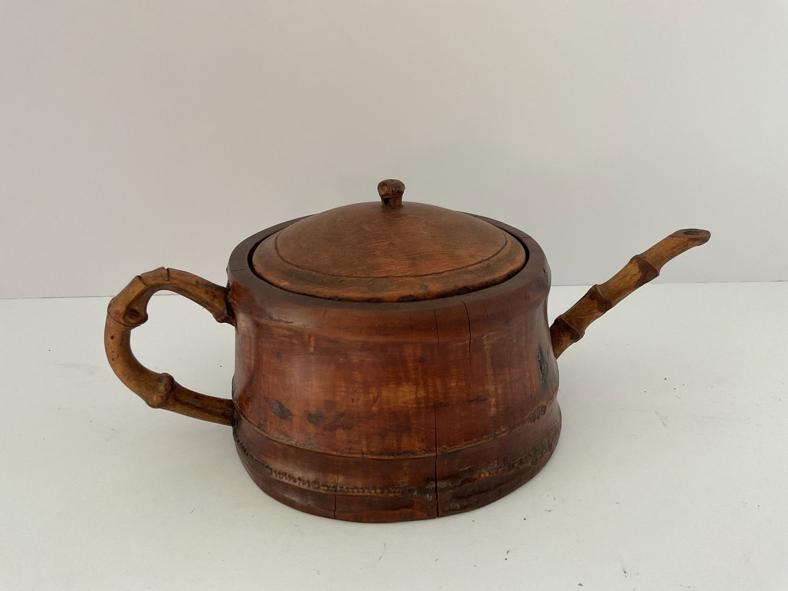 Hand Carved Bamboo Root Teapot: An antique hand carved bamboo root teapot. Simple design, it measures approximately 8'h x 10" at the spout.