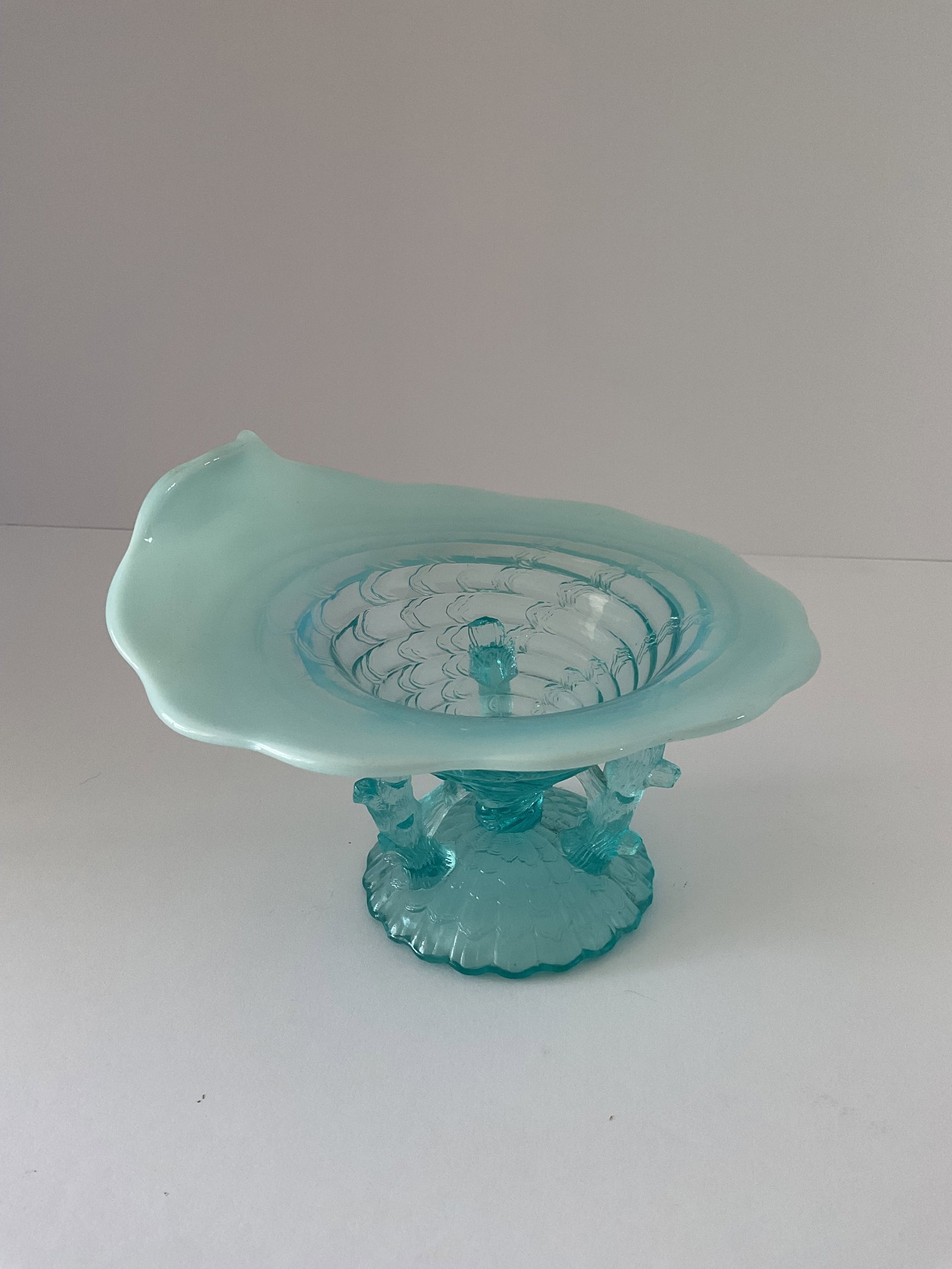 Northwood Opalescent Ocean Shell Bowl: A Northwood opalescent glass bowl. This piece is in the 'Ocean' pattern introduced in 1903. This has applied figural supports with an opalescent rim. it measures approximately 4"h x 7" in diameter. Fi