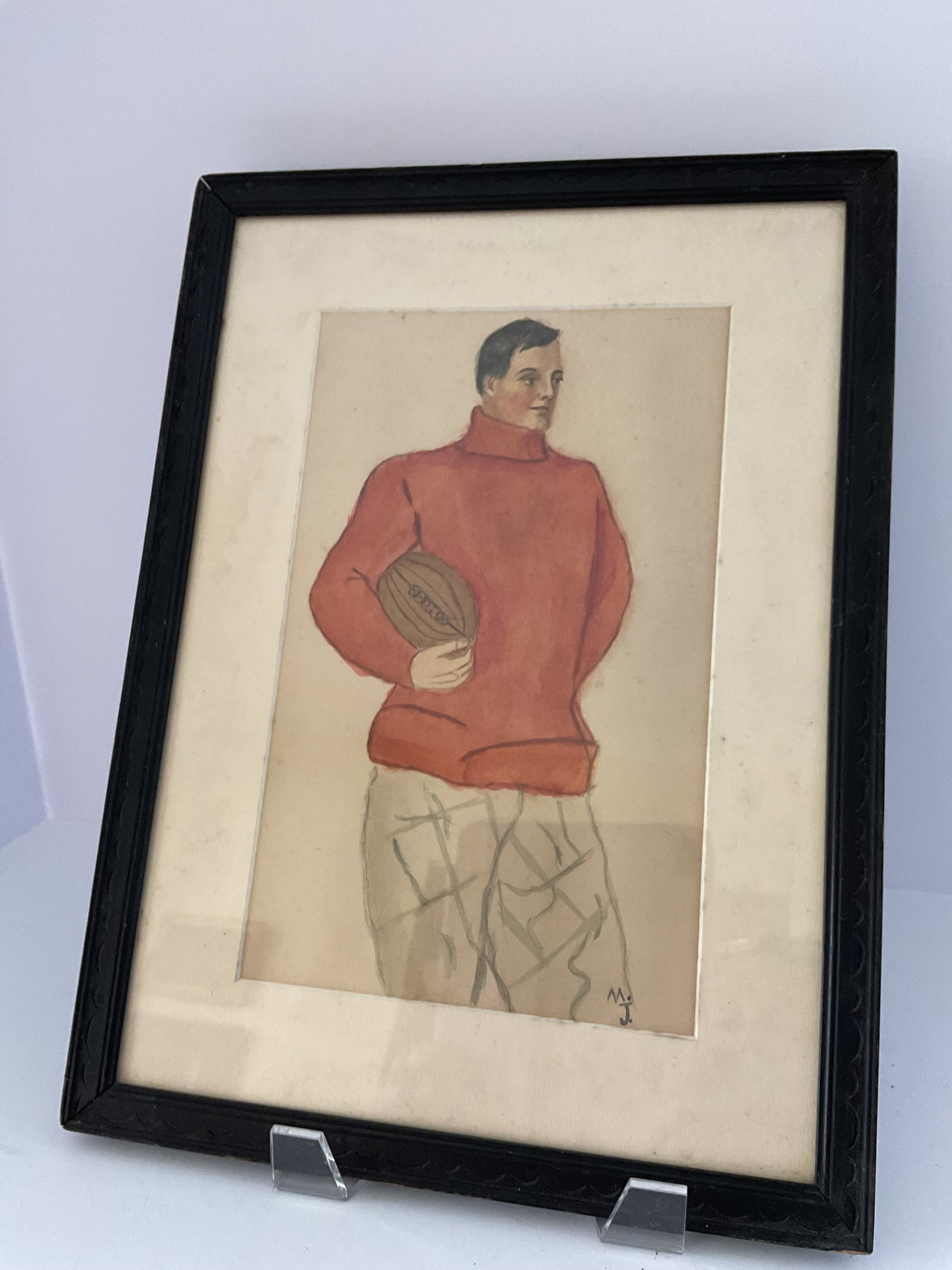 Early 20th Century Illustration of a Football Player Watercolor on Paper: A 19th century circa 1905 watercolor depicting an early footballer. Used from Ralph Lauren's archives for storefront display. Simply framed in period wood behind glass with 100% rag mat. 15 x 11"