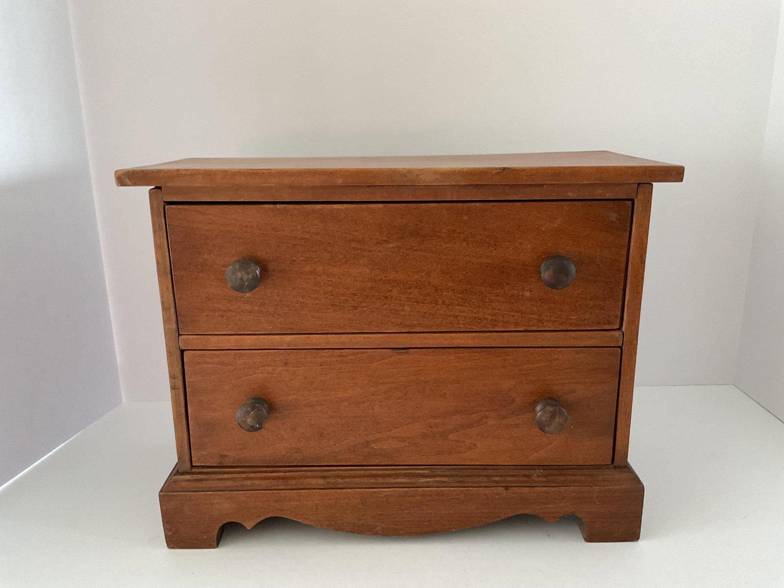Late 19th Century Lancaster County, Pennsylvania Two Drawer Miniature Chippendale Chest: A very nice early Lancaster County, Pennsylvania miniature Chippendale walnut (poplar secondary) chest. It measures 10"h x 12.5"w x 6"d. Minor stain loss to top. It has the original knobs and an ornat