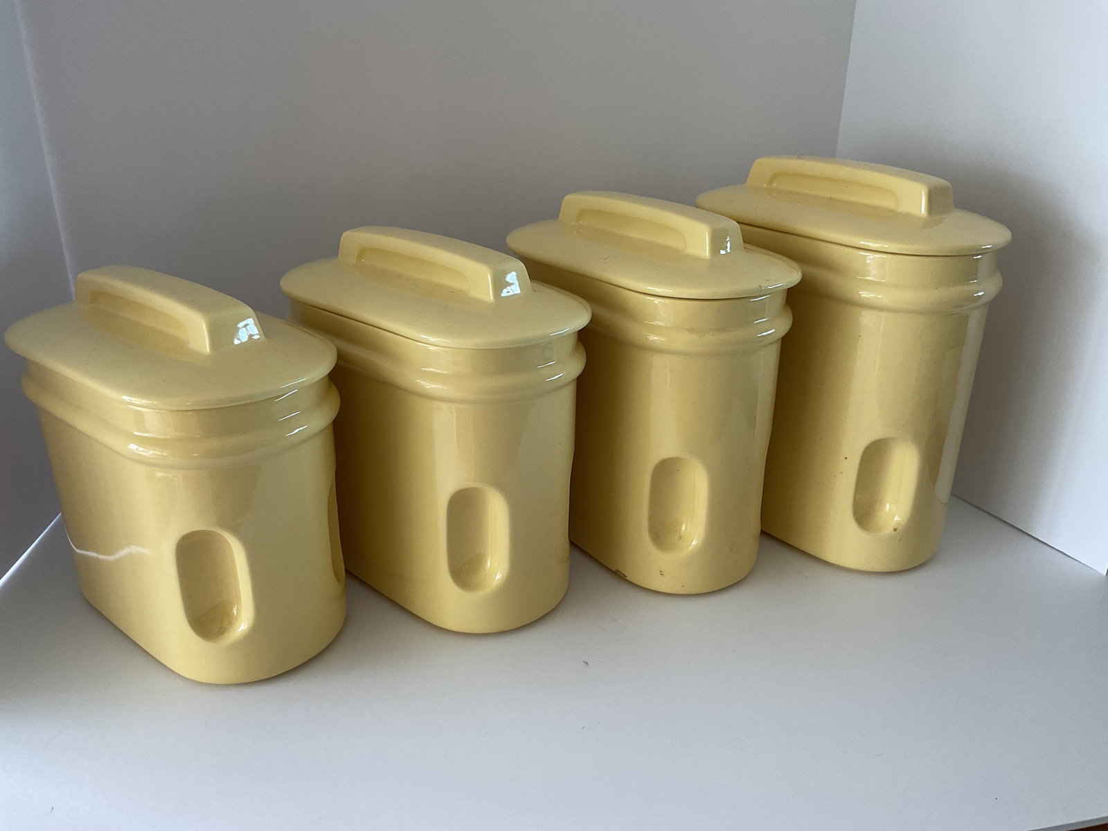 Rare Mid Century Royal Haeger Cannister Set: A four piece mid century Royal Haeger canister set in butter yellow. In exceptionally good condition. The largest is 9 x 9 x 5" and the smallest is 7 x 8 x 5".