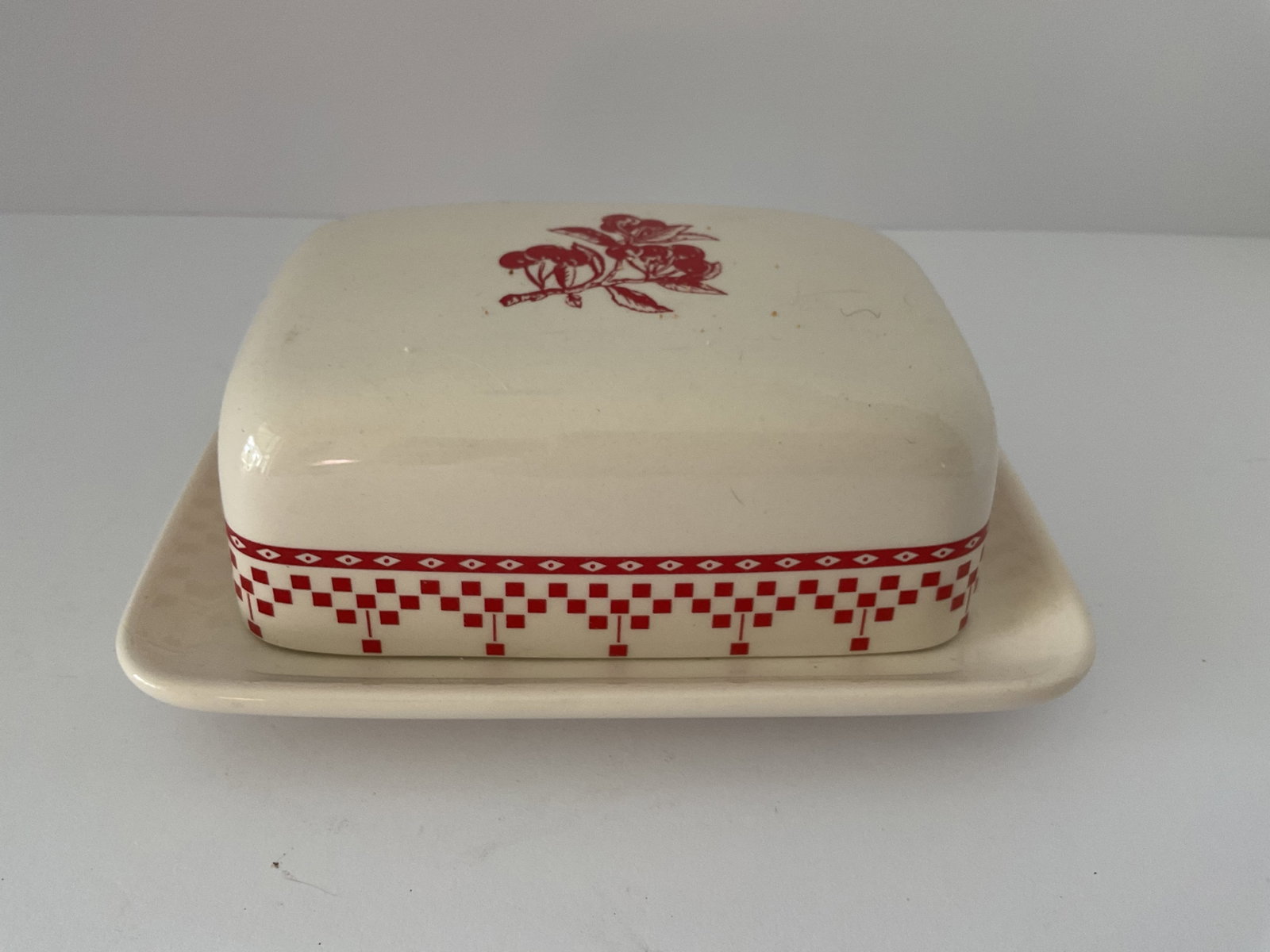 French Butter Dish: A ceramic French butter dish with cover. Red and white classic design. It measures approximately 8 x 4 x 5"