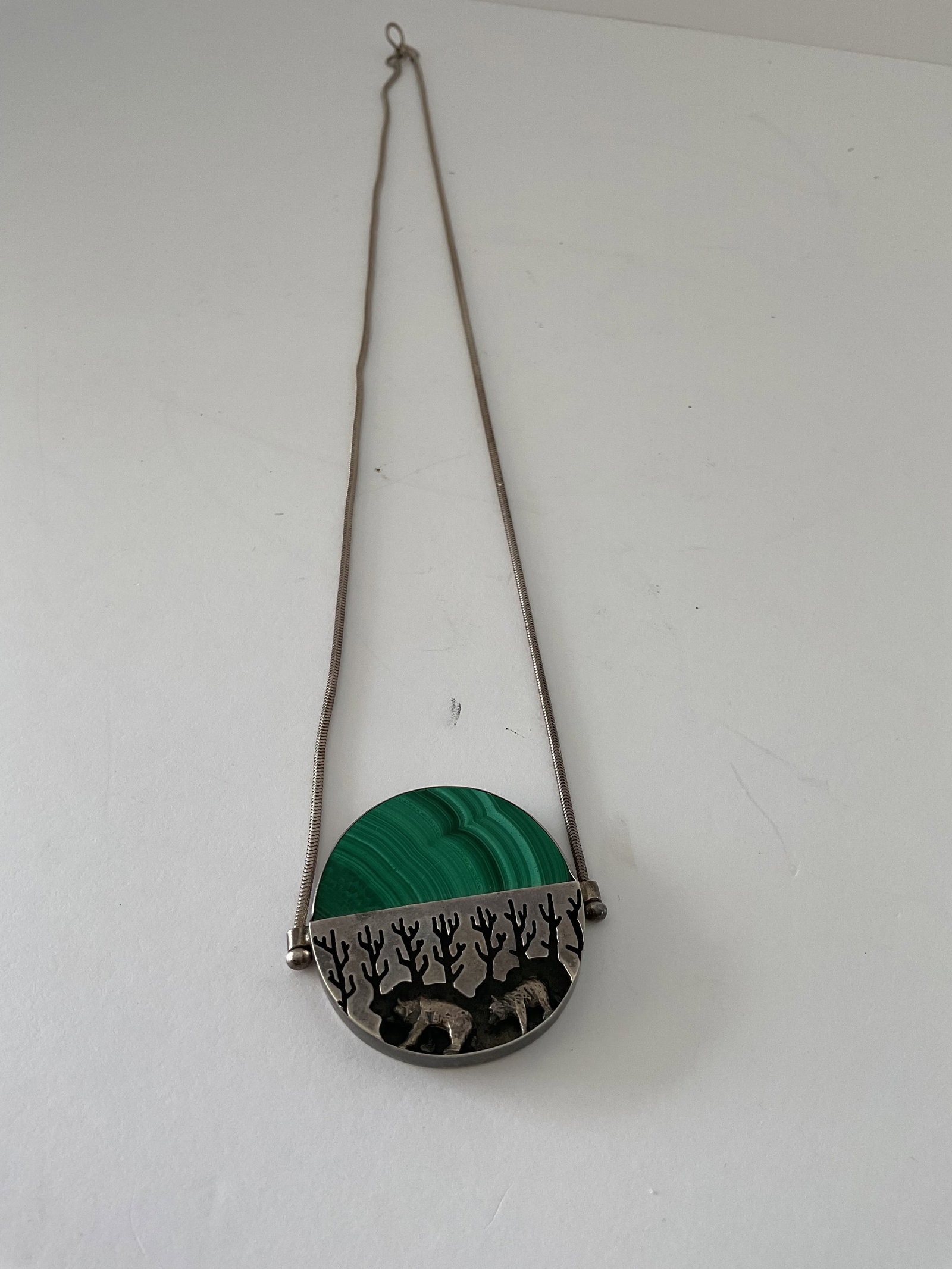 Great Falls Metal Works Sterling and Malachite Necklace: A beautifly crafted necklace from Great Falls Metalworks. This sterling silver and malachite piece depicts two bears running in the woods. Please see the photos on this item - better seen. The pendant