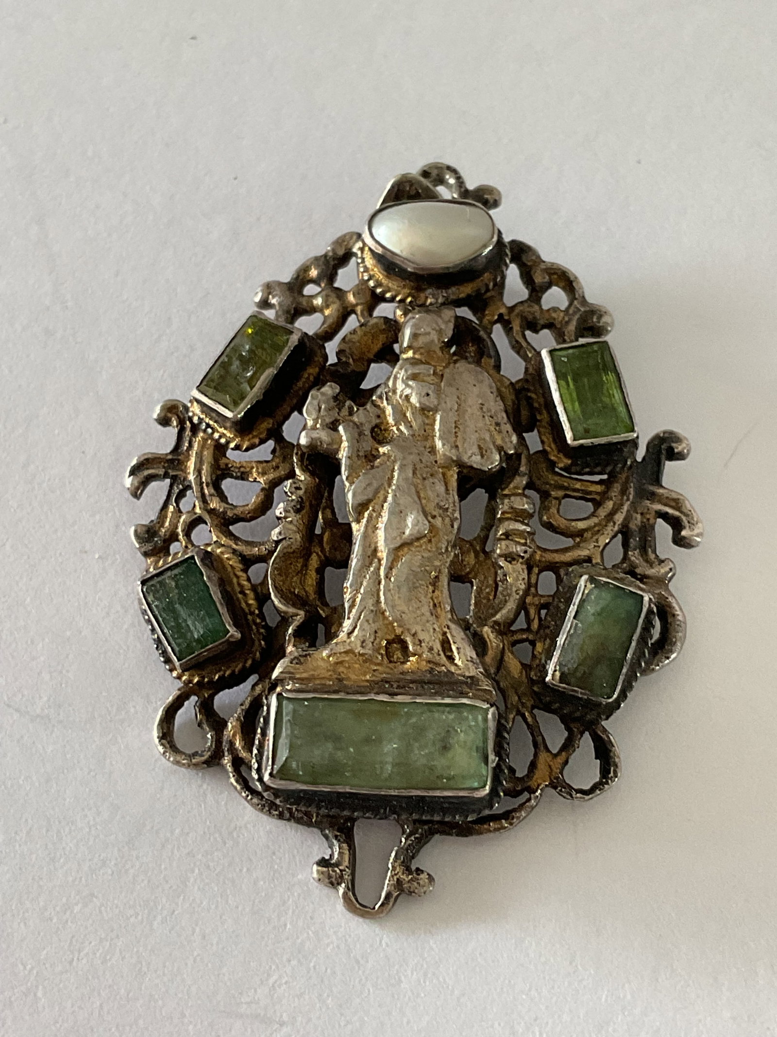 Austro - Hungarian Pendant: An Austro -Hungarian with green stones, pearl and figure. It is 17th/18th century sterling. It measures 1.5" and the weight inclusive of stones is 10.8 grams