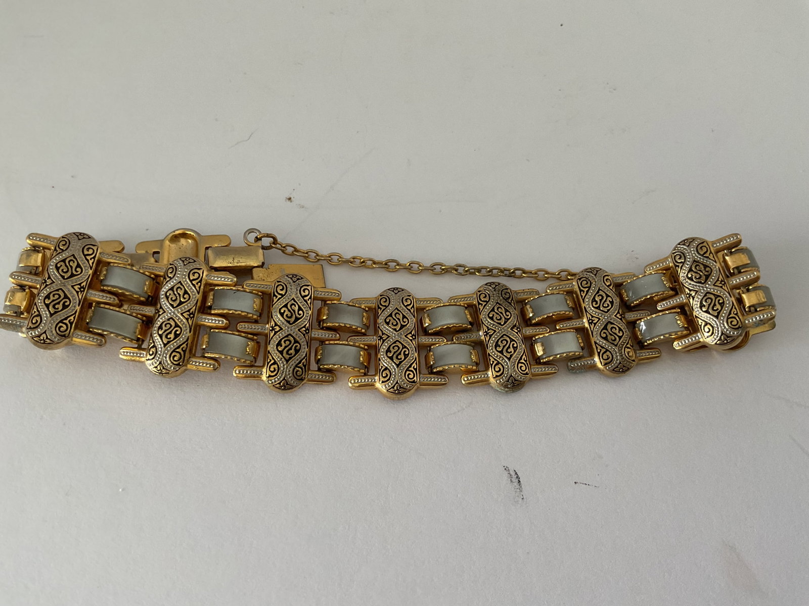 Damascene Gold Tone and Mother of Pearl Bracelet: A vintage Damascene gold tone and MOP bracelet. 6.5" in length.