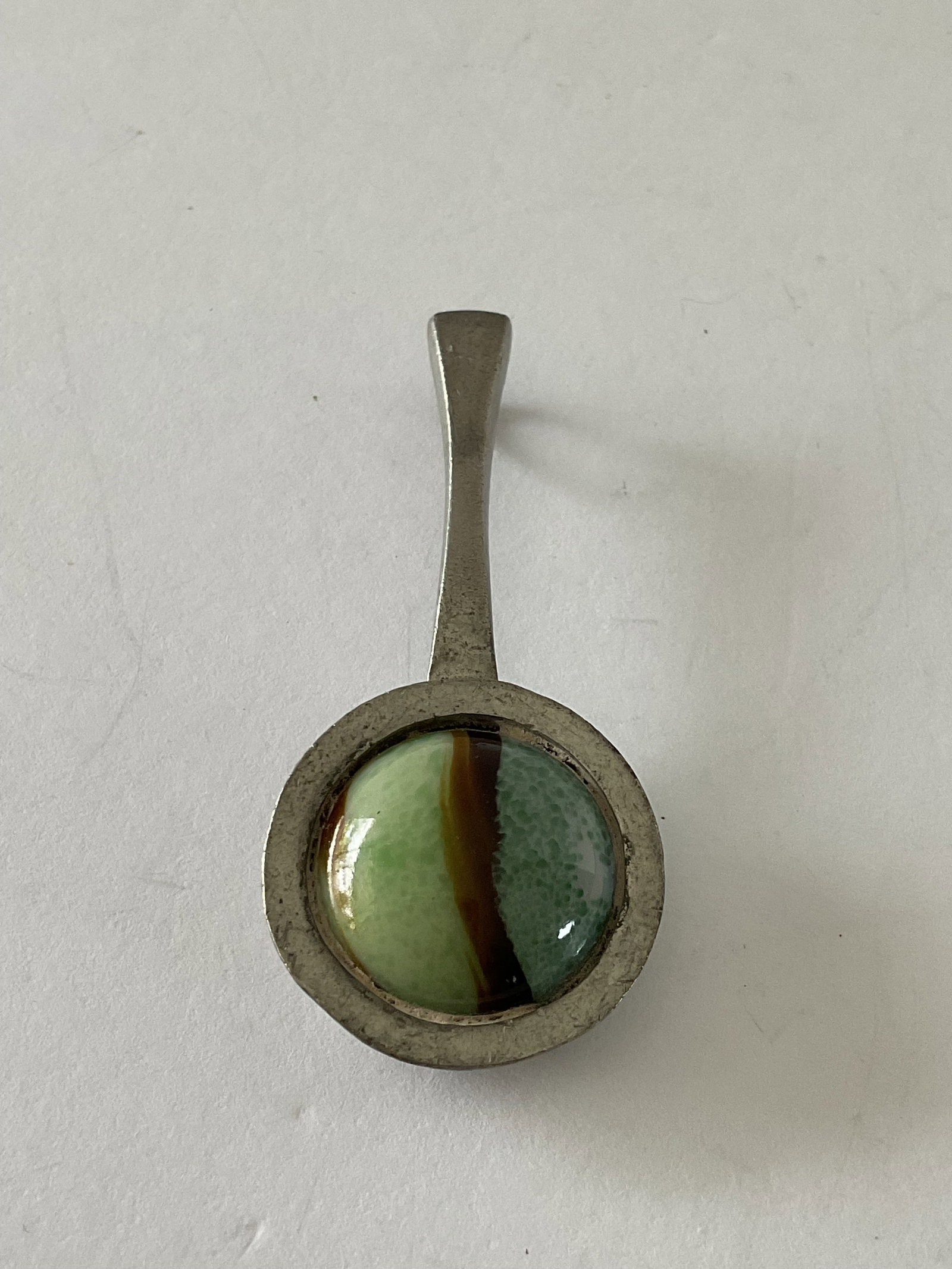 Mid Century Brent Larson Danish Pewter and Glass Pendant: A mid century pewter and glass handcrafted pendant. It measures 2" in length. Number 2256