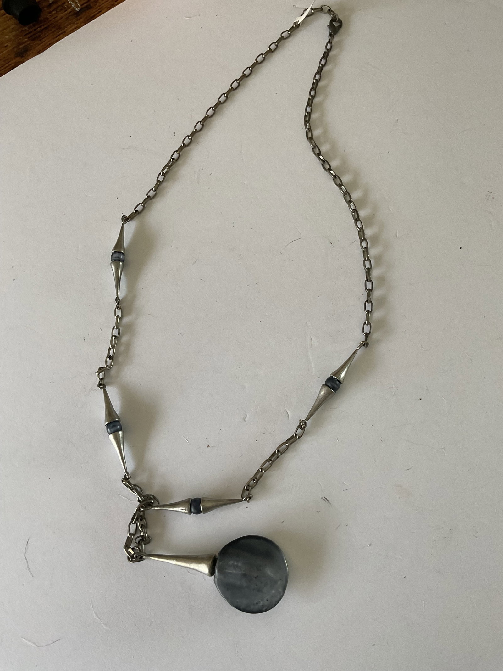 Mid 20th Century Pewter and Glass Scandinavian Necklace: A mid 20th century pewter and purple glass necklace. This piece appears to be handcrafted. I measures 32" in length.